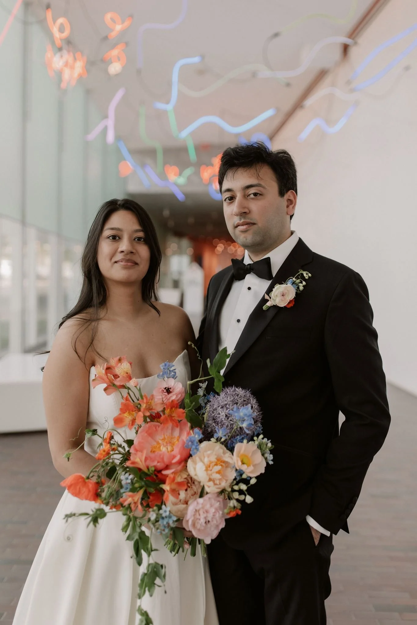Bride and groom with large bright bouquet at Walker Art - Asian couple
