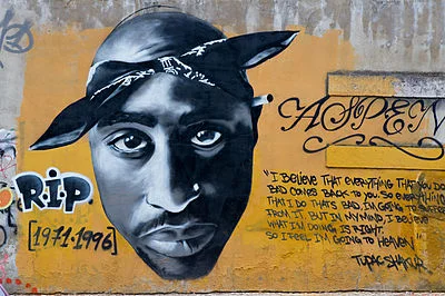 "This graffiti art is a tribute to West Coast rapper Tupac Shakur , who was killed in a drive-by shooting (photo r2hox from Madrid, Spain) (Wikimedia Commons)
