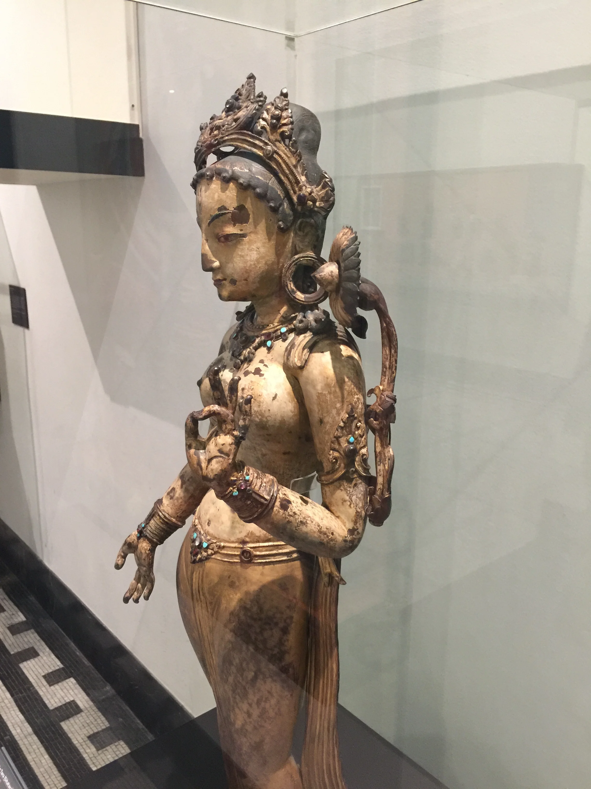 White Tara with lotus over shoulder and giving a blessing, Nepal, 1300-1400. In Buddhism, Tara is associated with liberation, compassion, and success. From the Victoria & Albert Museum.