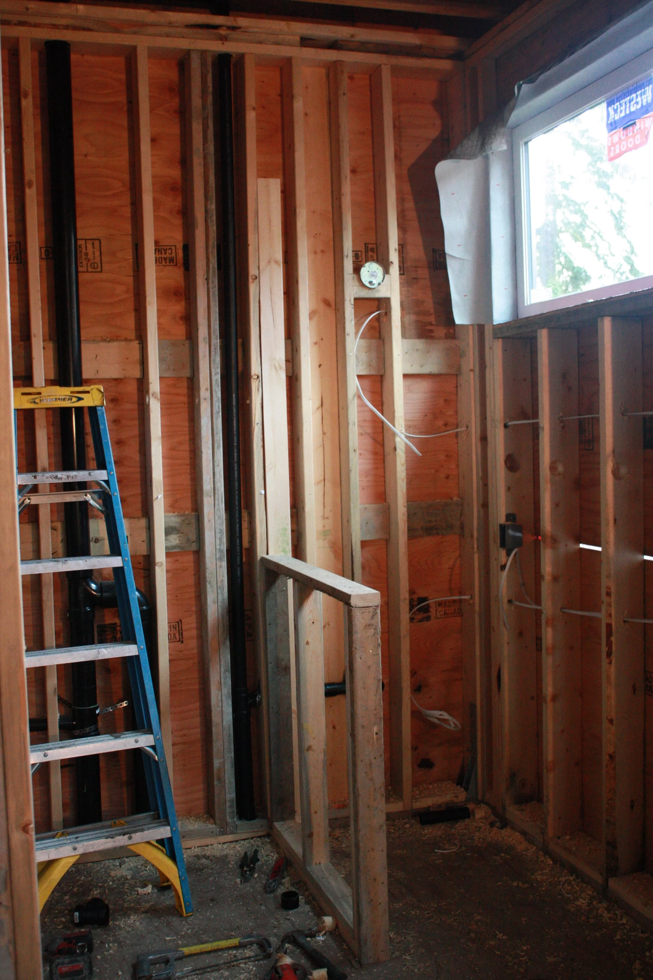 The ladder is in the den bathroom shower space.... to be removed. LOL