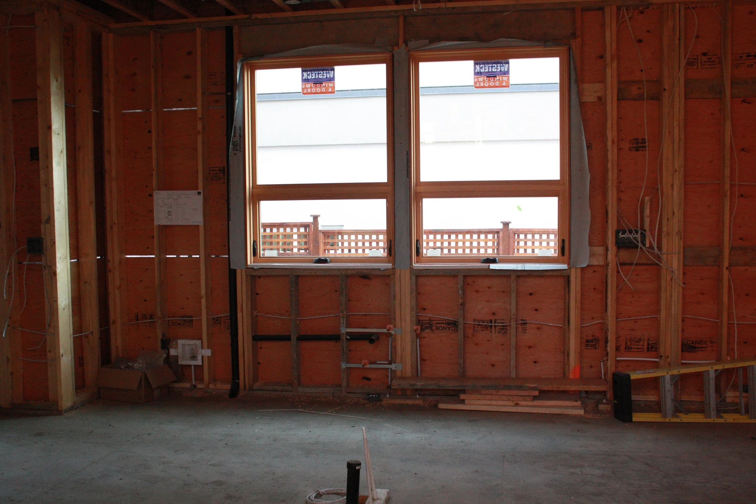 The other kitchen wall with plumbing and electrical fittings. 