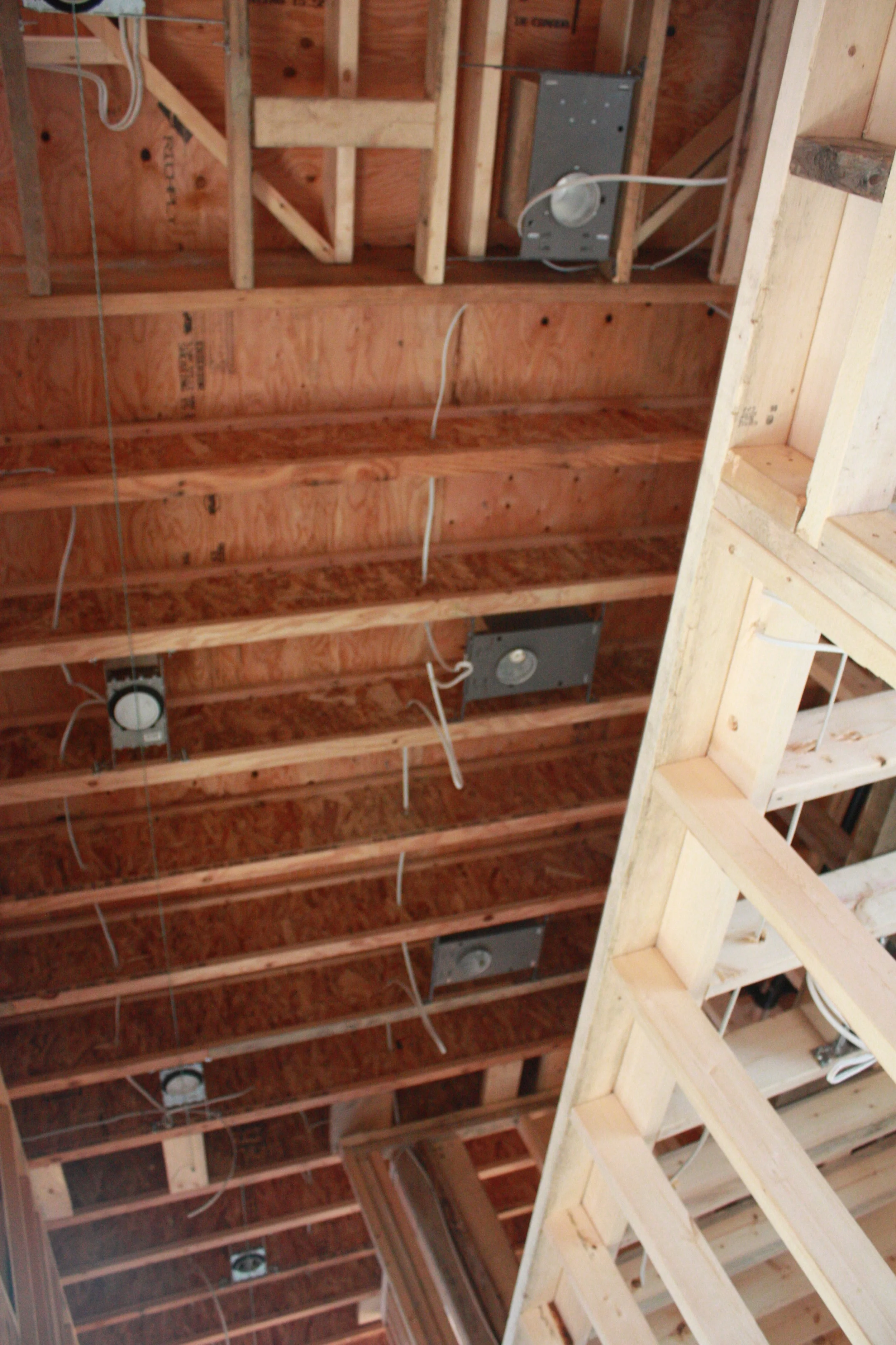 Recessed lighting in the upper hallway and low voltage lighting above the shelf created by the laundry room ceiling.