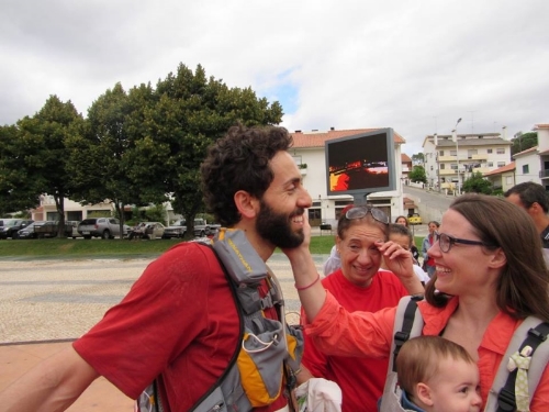 Levi is greeted by his wife, daughter, and mother upon crossing the finish line.