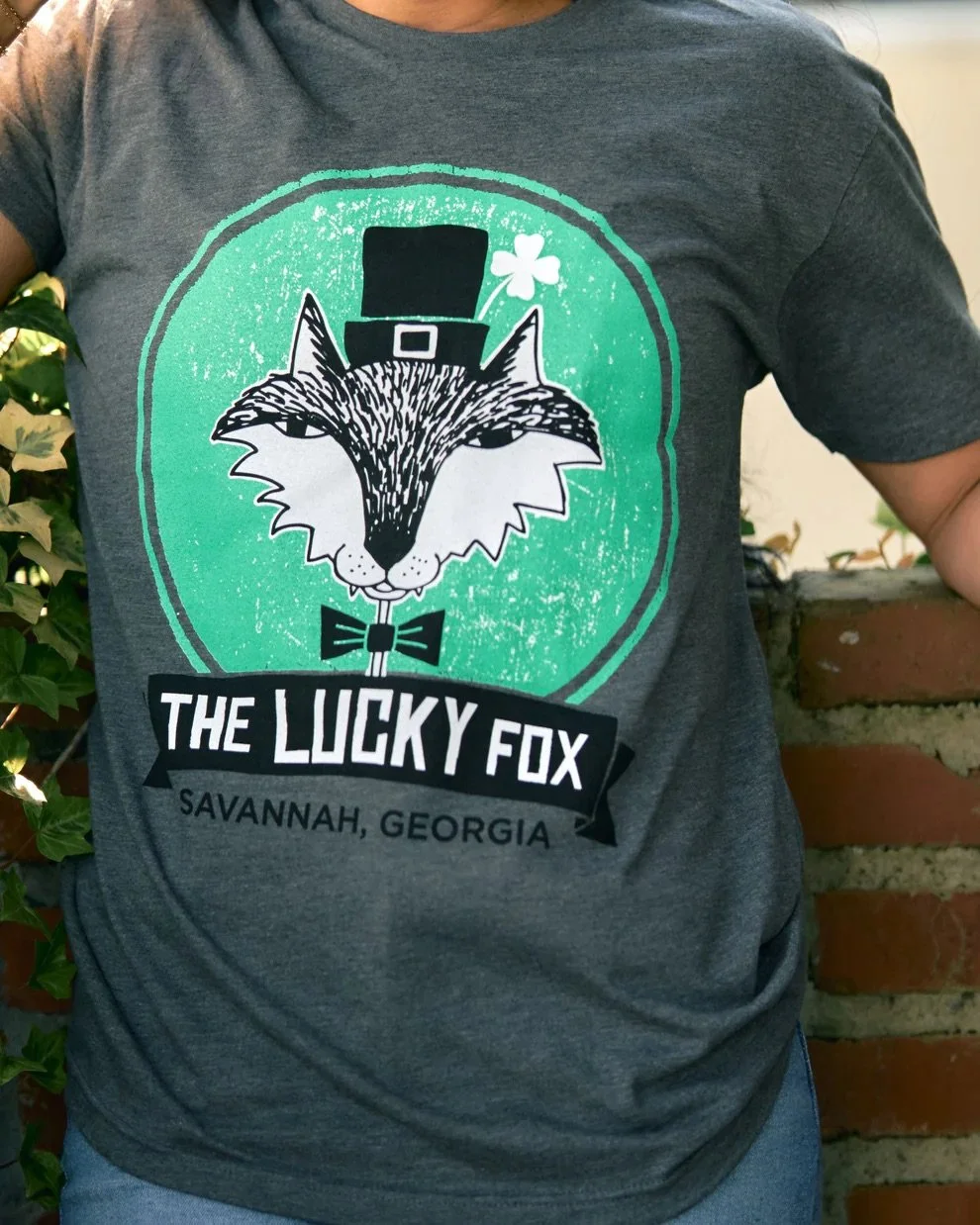 🍀✨ Feelin&rsquo; lucky, Savannah? Our Lucky Fox Tee is officially restocked and ready just in time for St. Patrick&rsquo;s Day!

Grab yours online or swing by the caf&eacute; before the parade on March 17. ☘️🦊

#TheCoffeeFox #LuckyFoxTee #StPatrick