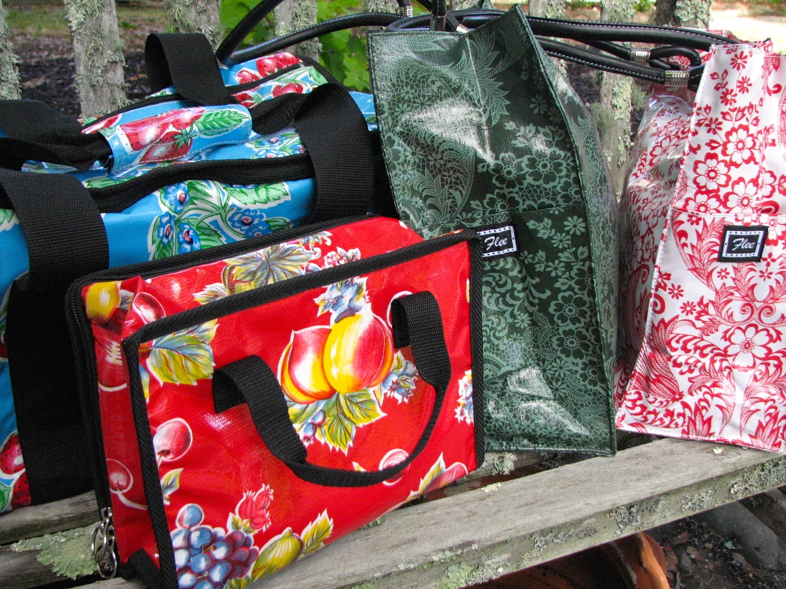 flee bags in heavy oilcloth and cheery patterns.