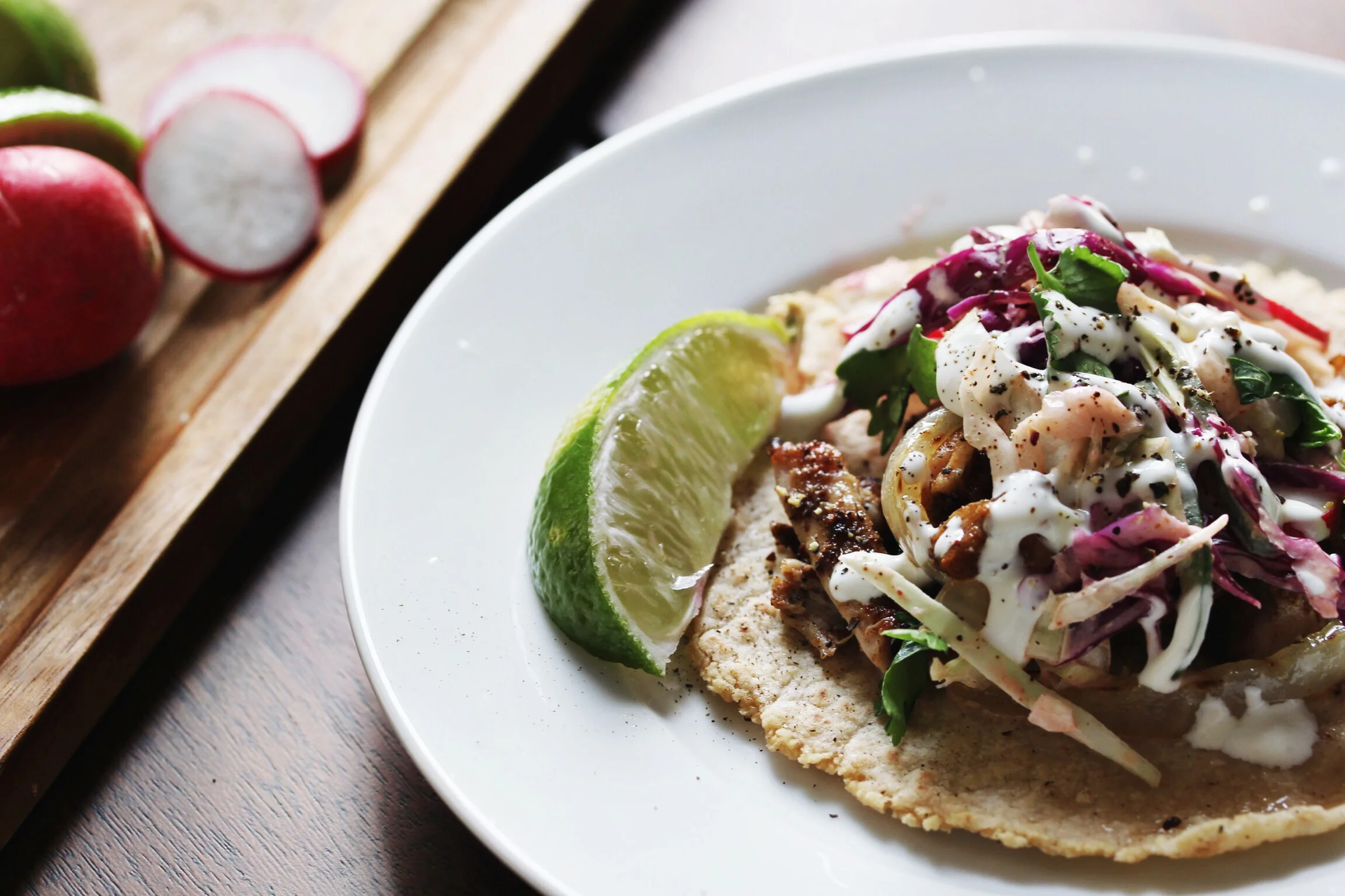 Dry rub chicken street tacos with slaw, grilled onion, and jalapeño lime crema - The Pastiche