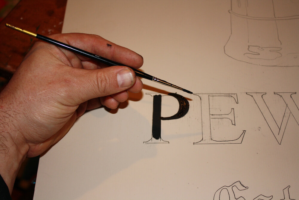 colonial american sign company_andy walker holding paintbrush_lettering process.jpeg