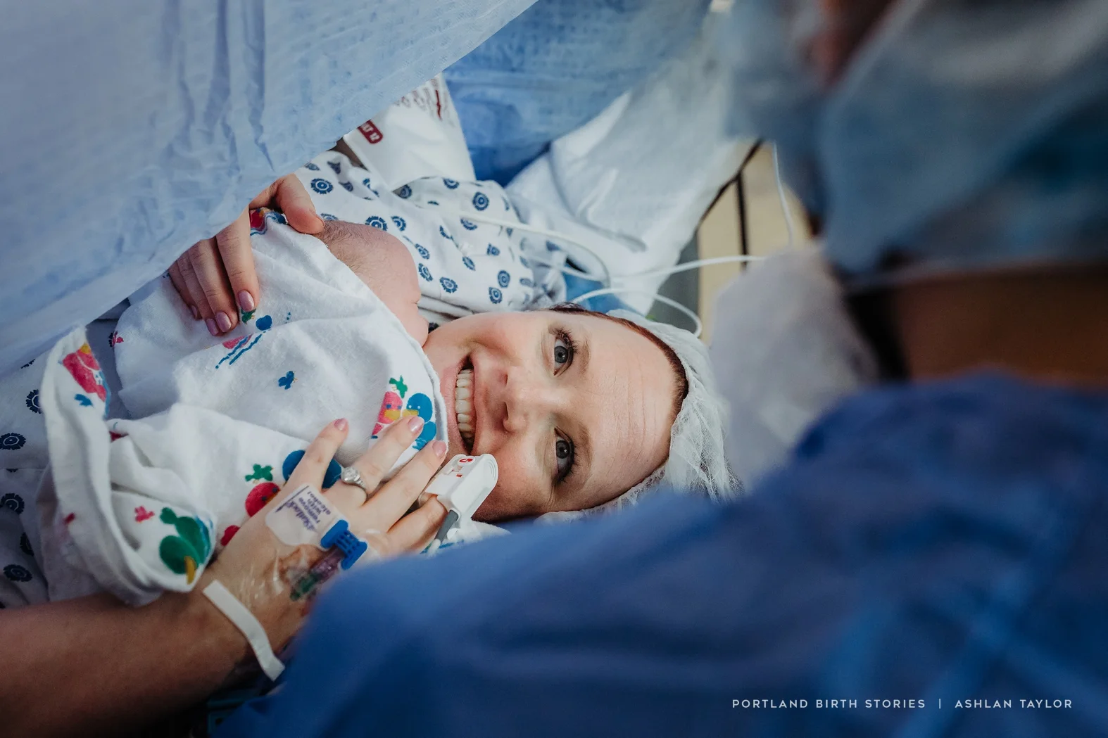 Holding newborn baby on operating table