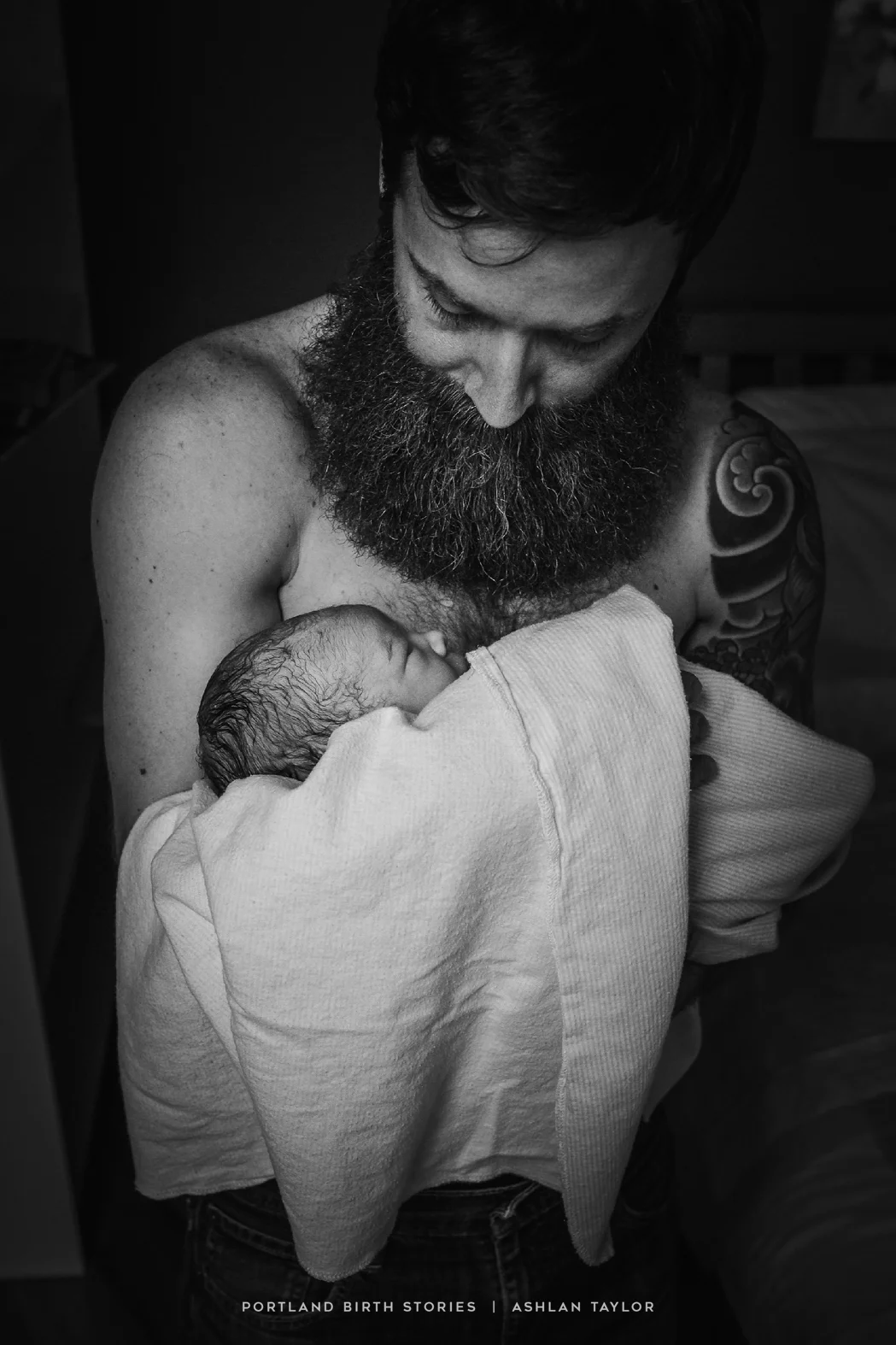 Father holds new baby after home birth