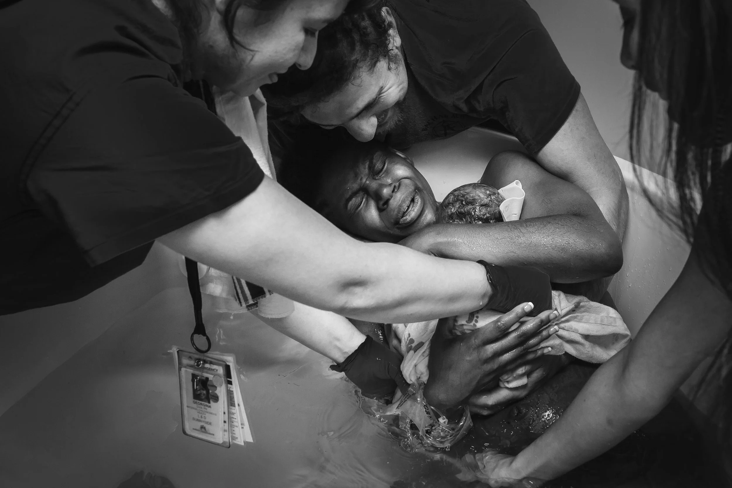 Baby born into mothers arms in hospital water birth