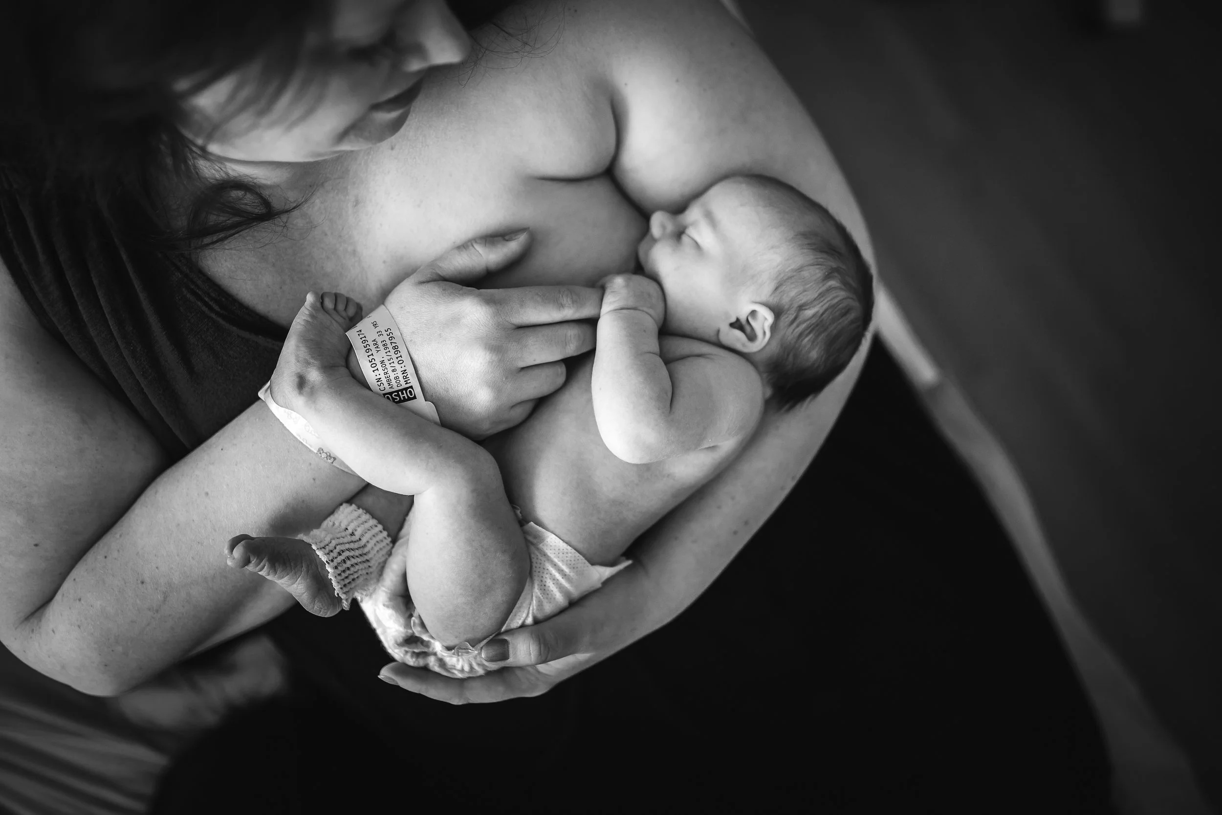 breastfeeding newborn with mother after birth