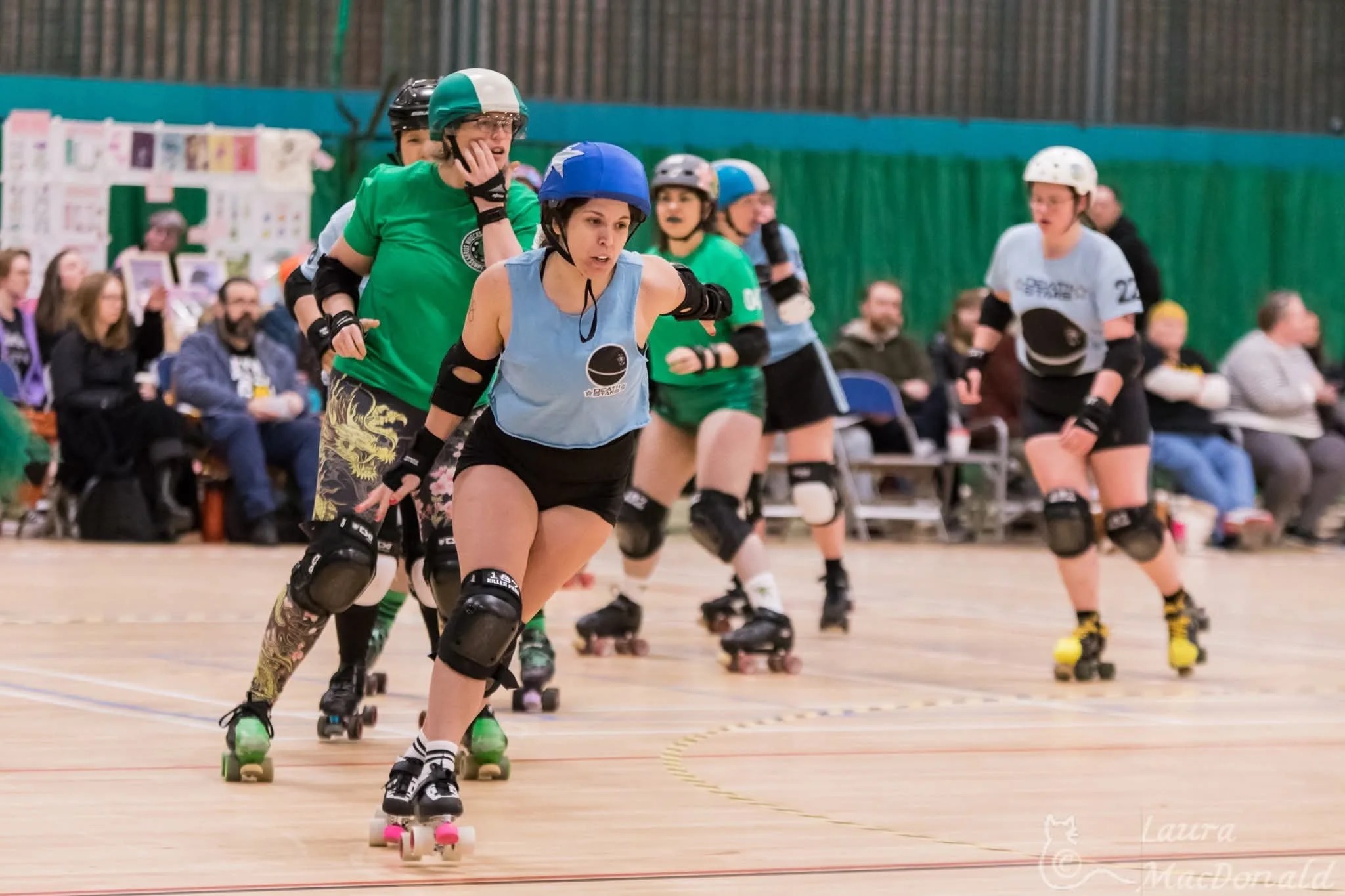 Taco is skating in a light blue Death Stars shirt and wearing a blue jammer helmet cover
