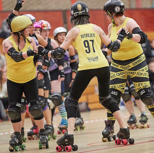 Mad Natter, NitroJen & Sadie O'Hades waiting for the offense; photo courtesy of Roller Derby on Film .