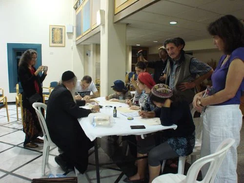 Teacher and Mentor, Dov Laimon (left) teaches a scribing workshop