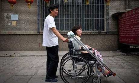 Disabled Chinese rights activist Ni Yulan and her husband Dong Jiqin. Photo: Andy Wong/Associated Press