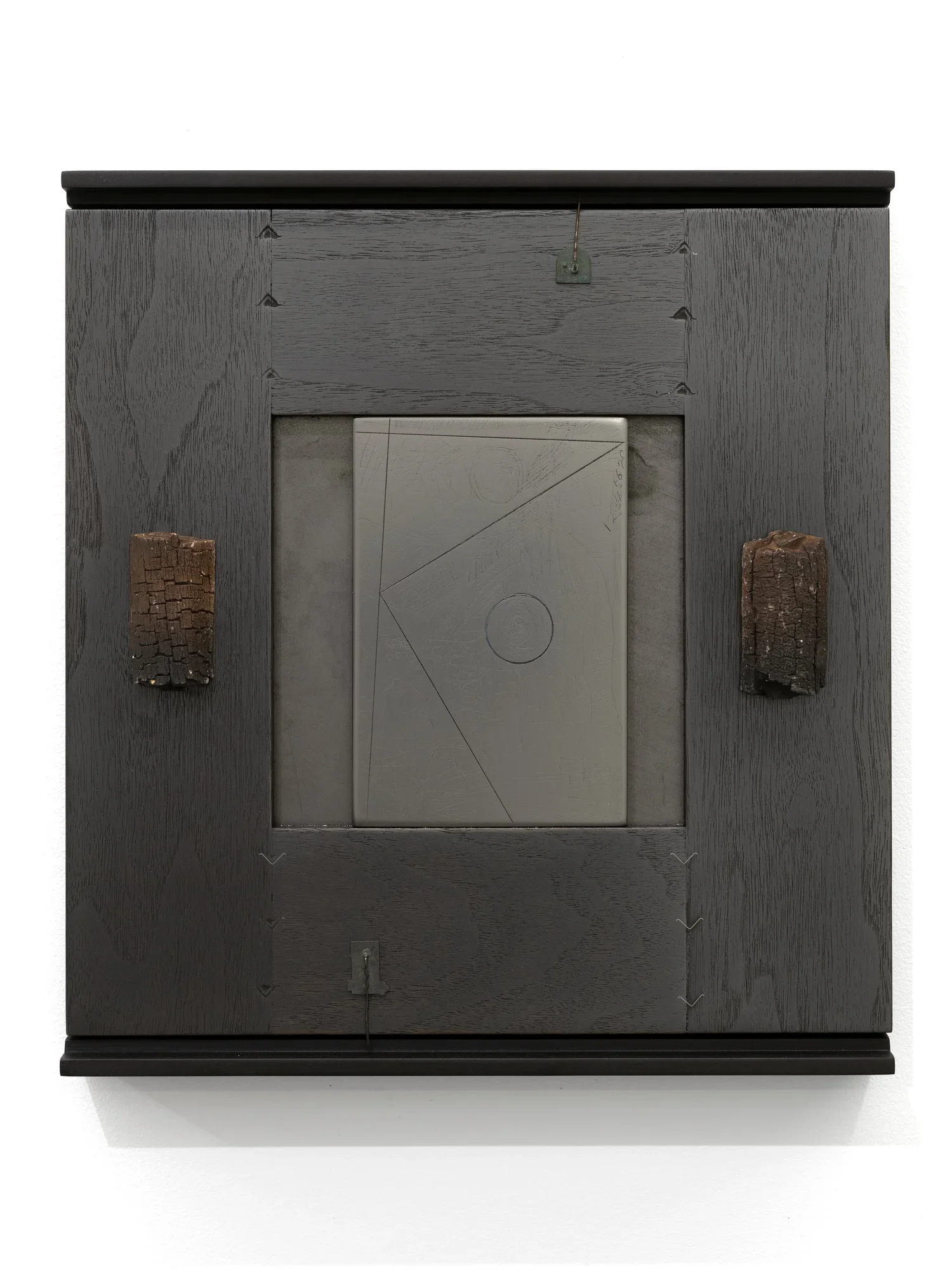 Self Portrait - Burnt, 2024, Wood, graphite panel, and plaster, 13 x 12 x 1 3/4 inches
