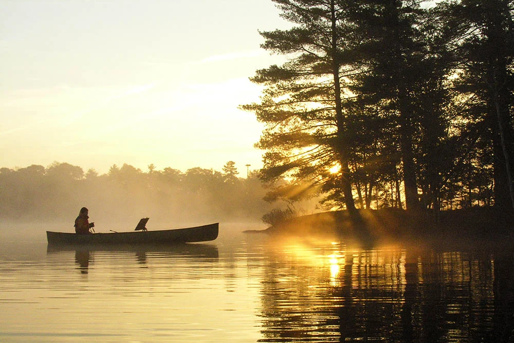David painting on a canoe