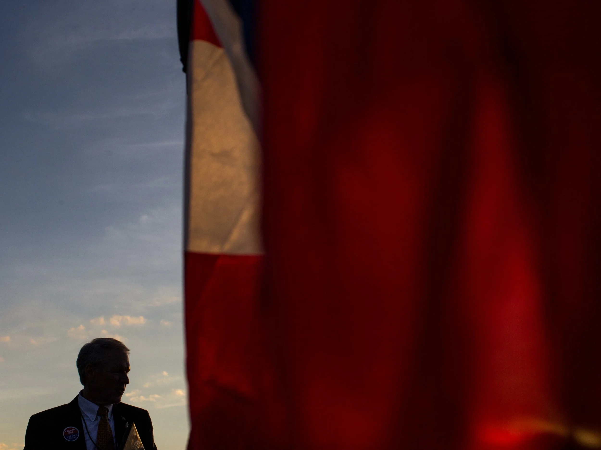 A man is silhouetted against the sky, Monday, Nov. 30, 2015 at the Macon Centreplex in Macon, Ga. where Republican presidential candidate Donald Trump is set to hold a campaign rally . (AP Photo/Branden Camp)