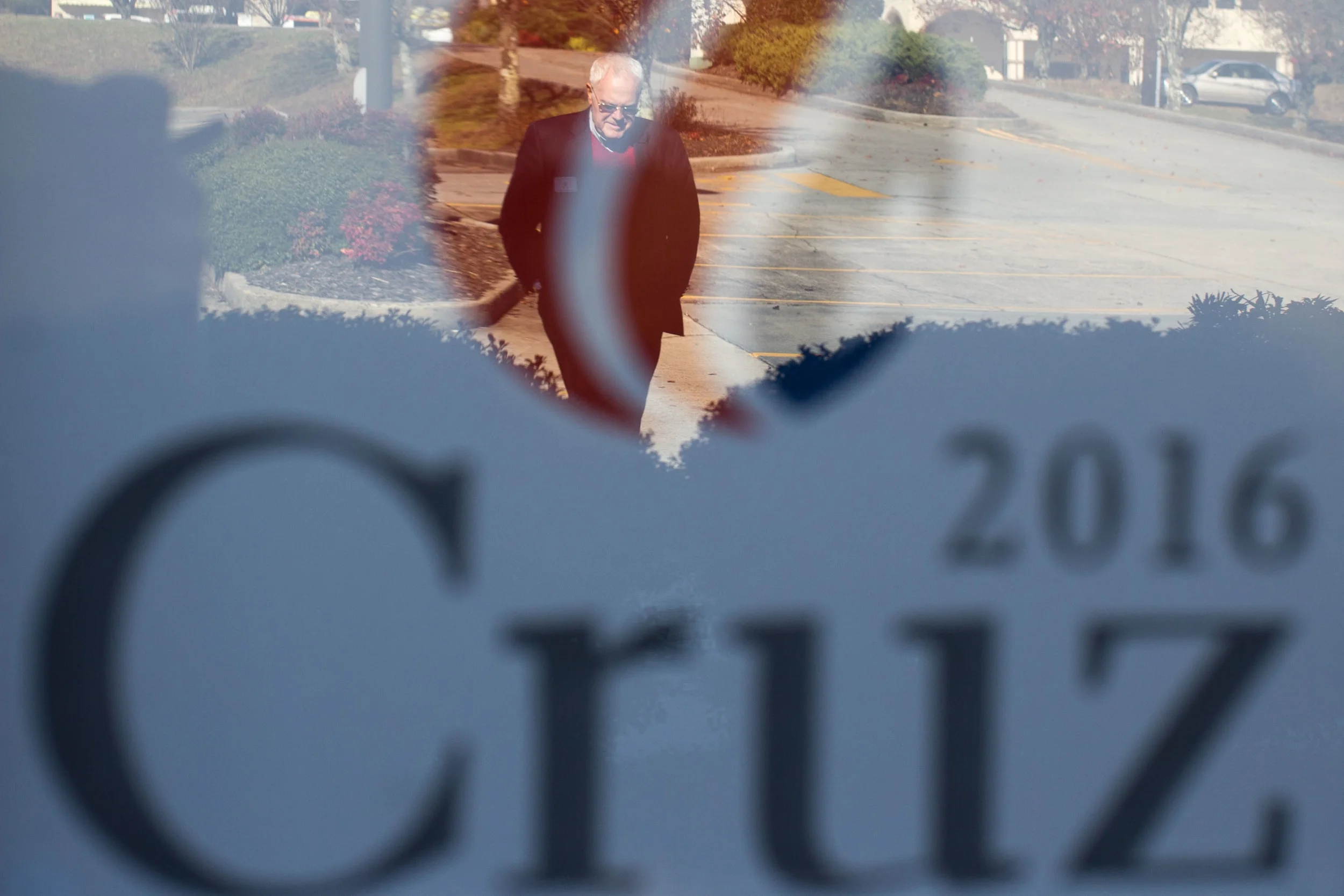 Joe McCutchen, supporter of Republican presidential candidate Ted Cruz, is reflected in a window of a local business, Saturday, Dec. 5, 2015, in Ellijay, Ga. McCutchen spends as much as 8 hours a day campaigning for Cruz in Georgia. BRANDEN CAMP FOR THE BOSTON GLOBE