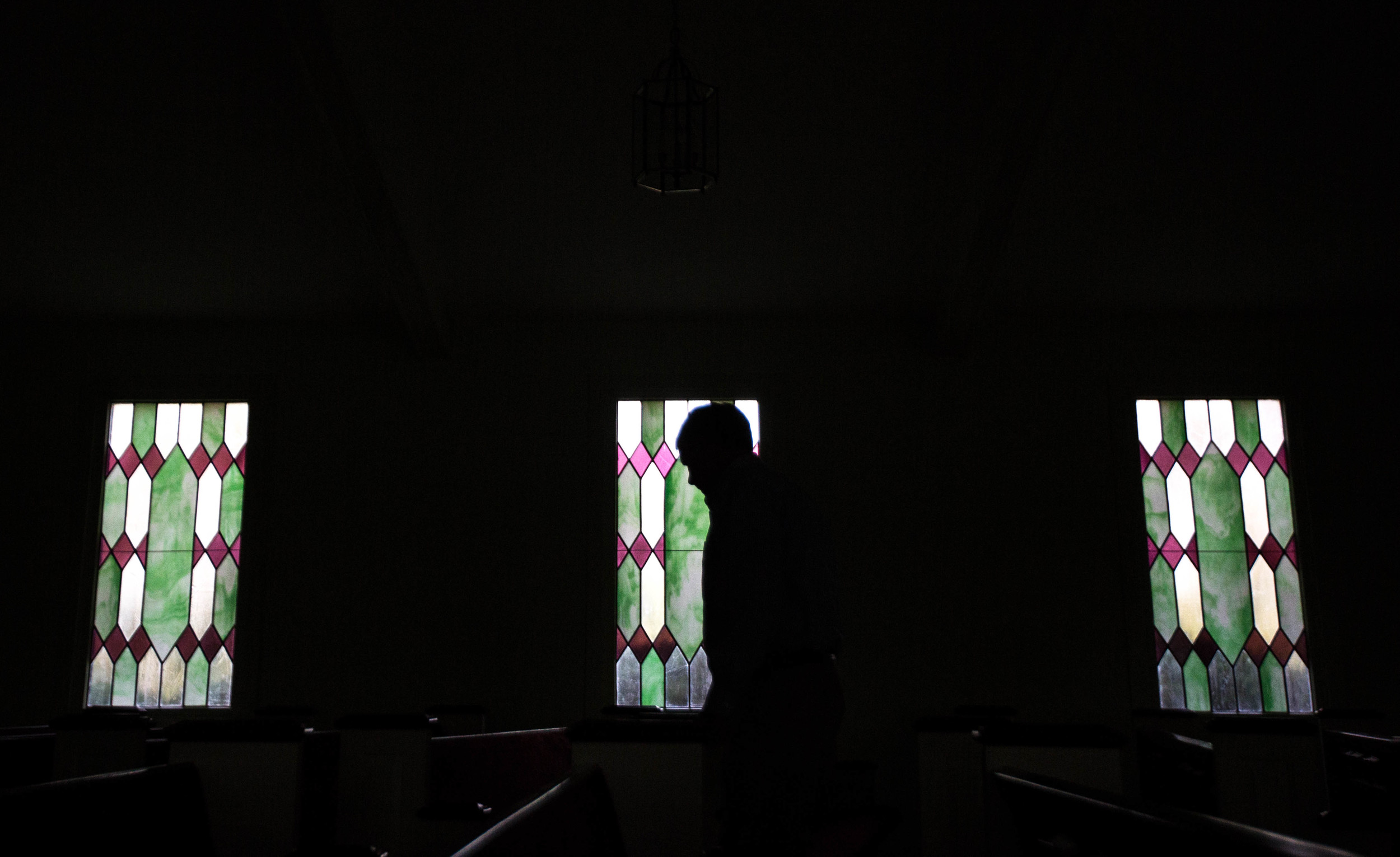 A church member cleans up the sanctuary after former President Jimmy Carter taught Sunday School class at Maranatha Baptist Church in his hometown, Sunday, Dec. 13, 2015, in Plains, Ga. A recent MRI showing no cancer on Jimmy Carter's brain is "very positive" news for the former president but will not end his medical treatment, doctors said. Carter, 91, announced on Dec. 6 that doctors found no evidence of the four lesions discovered on his brain this summer and no signs of new cancer growth. (AP Photo/Branden Camp)