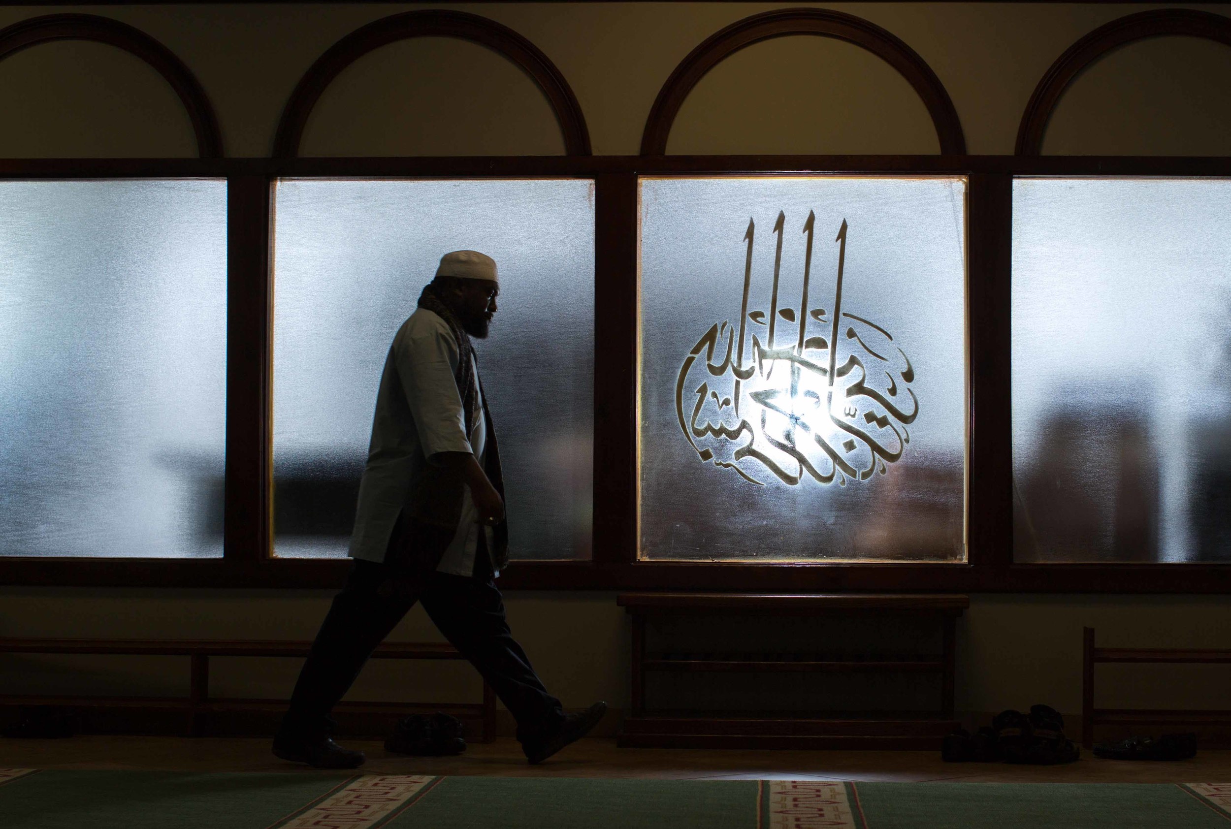 In this Sunday, Aug. 30, 2015 photo, Imam Suleimaan Hamed, the leader of the Atlanta Masjid of Al Islam mosque, walks through the mosque, in Atlanta. Members of the mosque gathered to celebrate a group of pilgrims who will make the annual hajj pilgrimage to the holy city of Mecca. (AP Photo/Branden Camp)