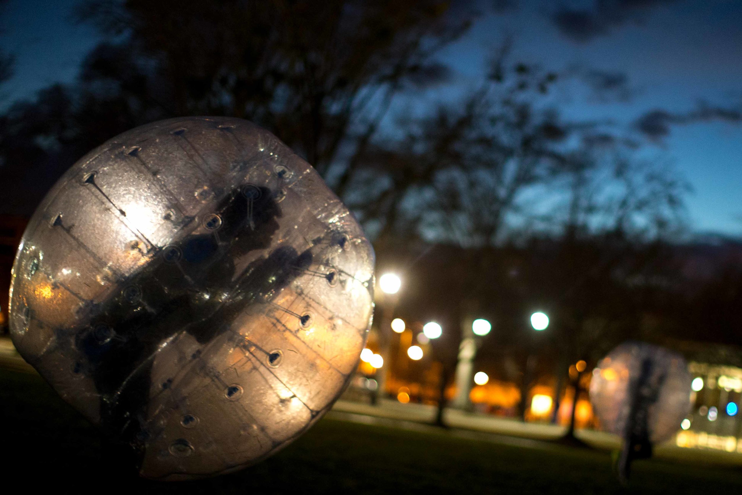 Kennesaw State University students play a game of bubble soccer on campus at sunset, Thursday, Jan. 28, 2016, in Kennesaw, Ga. (AP Photo/Branden Camp)