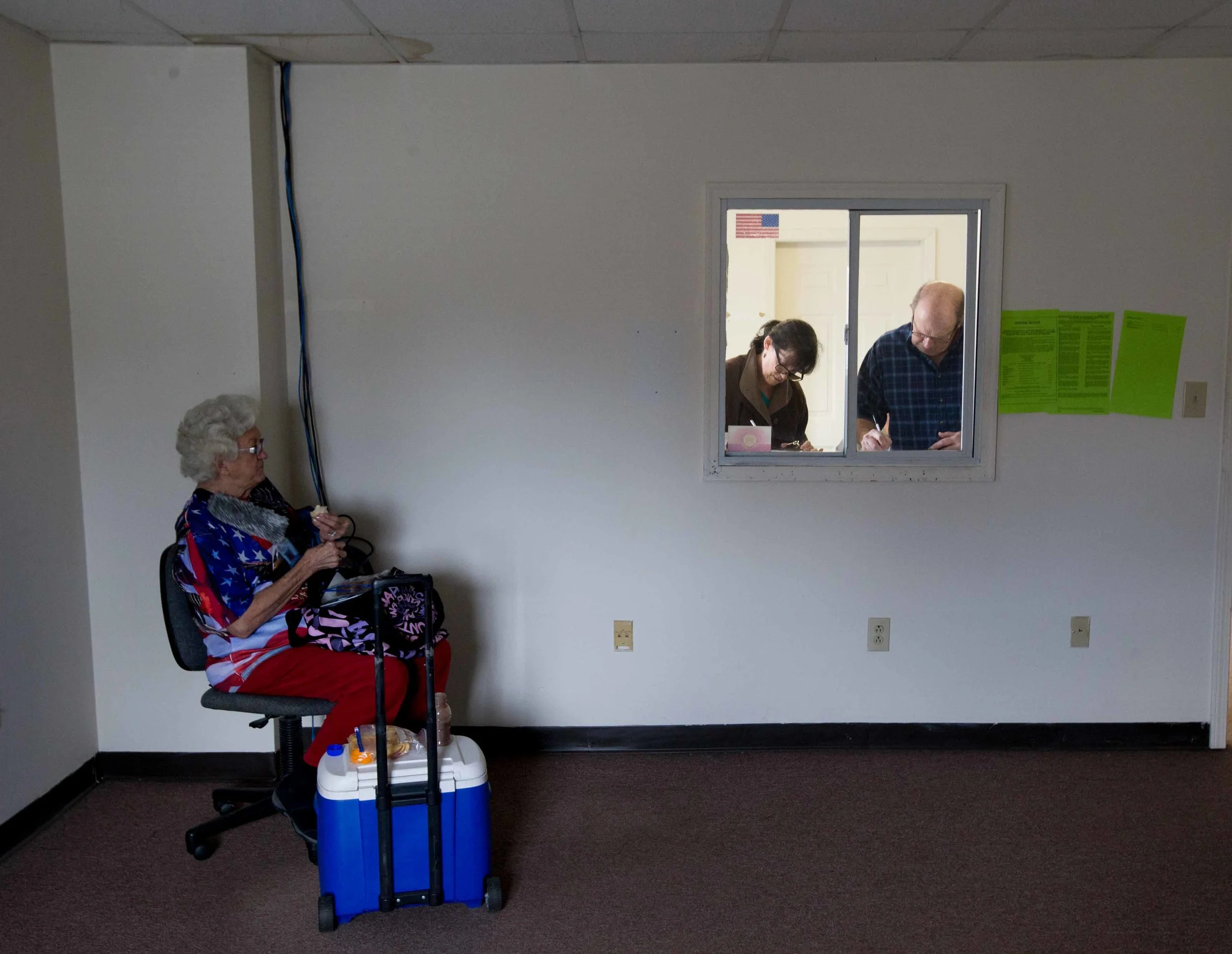 WHITE, GA - MARCH 1, 2016: 81-year-old Helen Free, left, a polling site assistant manager, takes a lunch break while two Georgia voters fill out voting paper work before casting their ballots on Super Tuesday March 1, 2016, in White, Georgia. Voters head to the polls to cast their votes on Georgia's presidential primary. (Photo by Branden Camp/Getty Images)
