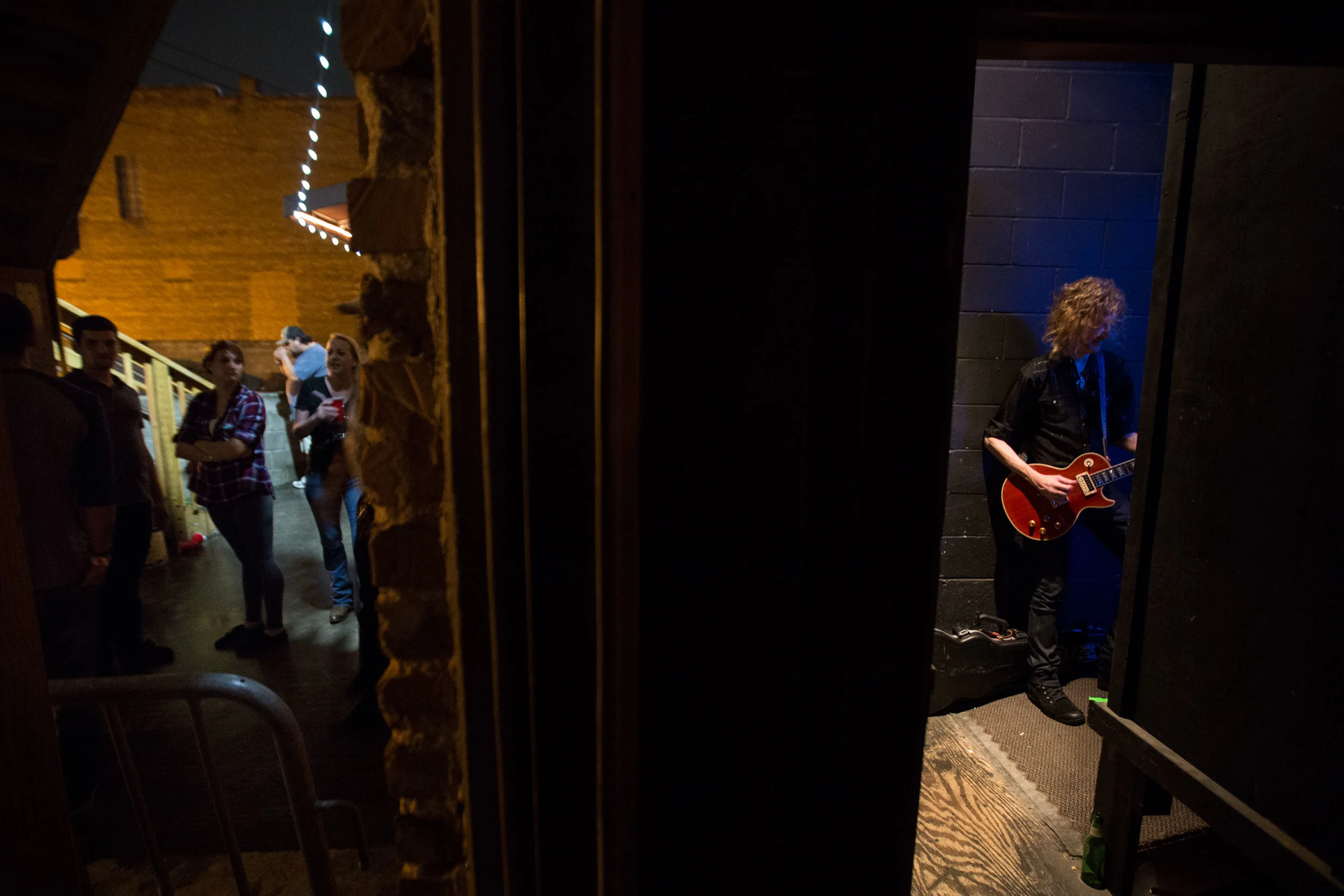 Guitarist Peter Stroud, right, waits backstage as fans crowd around outside The Crazy Bull music venue in Macon, Ga. Stroud is Sheryl Crow's guitarist and has played for artist such as Don Henley, Sarah McLachlan, The Dixie Chicks and Shawn Mullins).