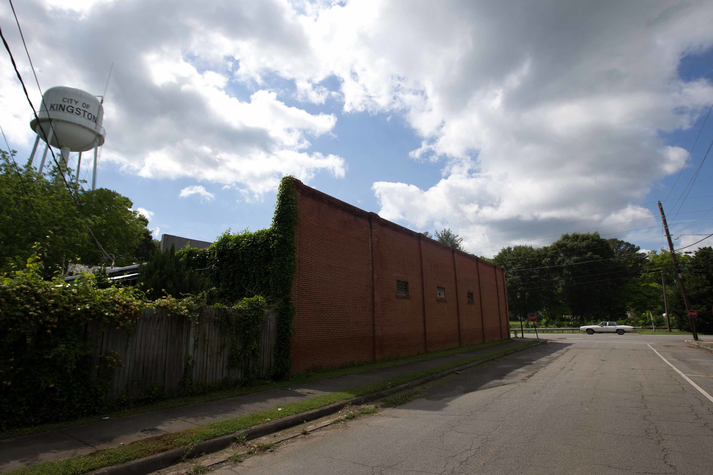  A car drives through a mostly vacant downtown Kingston, Ga. 