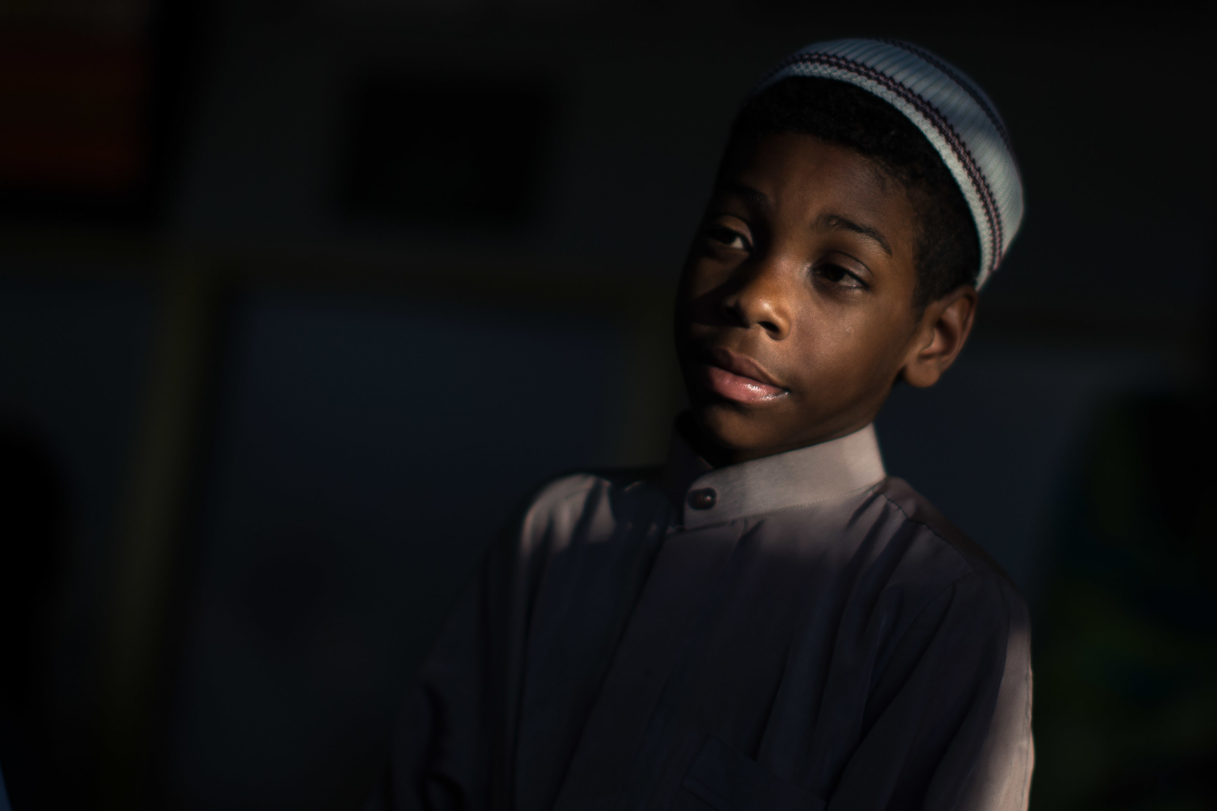 June 9, 2016 - Atlanta, Ga, U.S -Light shines on the face of a young boy at the Atlanta Masjid of Al Islam mosque in Atlanta. People gathered to honor the late Muhammad Ali, who died on June, 3, 2016, in Phoenix, Arizona.