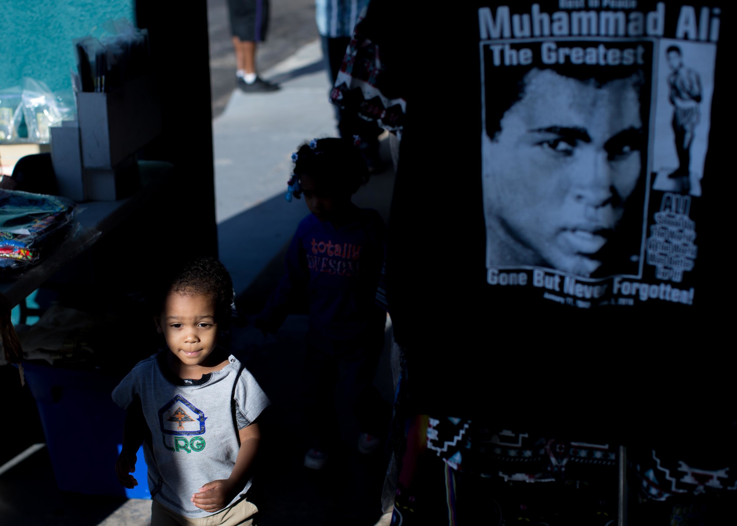June 9, 2016 - Atlanta, Ga, U.S - Children run past a Muhammad Ali shirt hanging on display at the Atlanta Masjid of Al Islam mosque in Atlanta. People gathered for an interfaith service to honor the late Muhammad Ali, who died on June, 3, 2016, in Phoenix, Arizona.