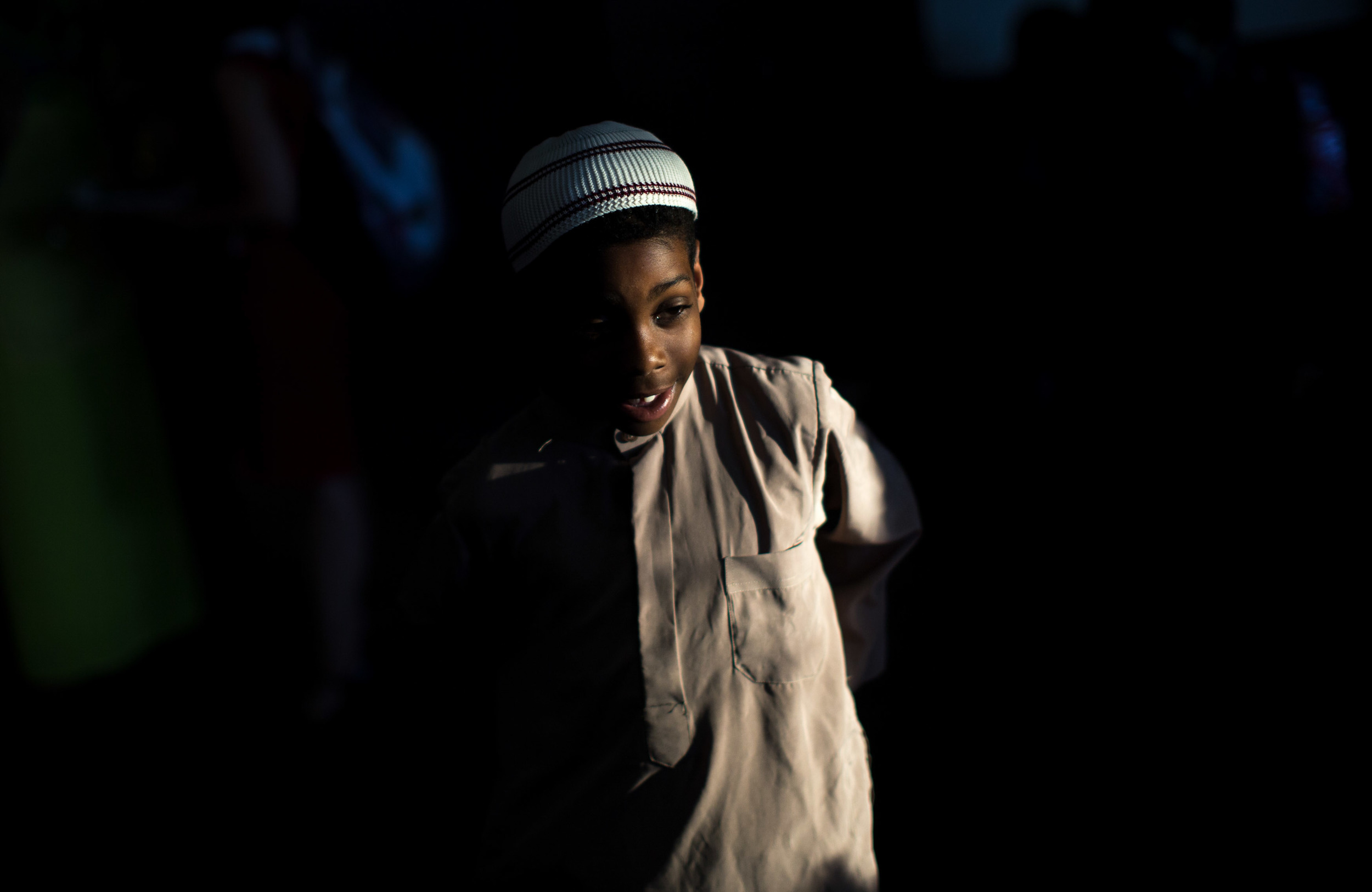 June 9, 2016 - Atlanta, Ga, U.S -Light shines on the face of a young boy at the Atlanta Masjid of Al Islam mosque in Atlanta. People gathered to honor the late Muhammad Ali, who died on June, 3, 2016, in Phoenix, Arizona.