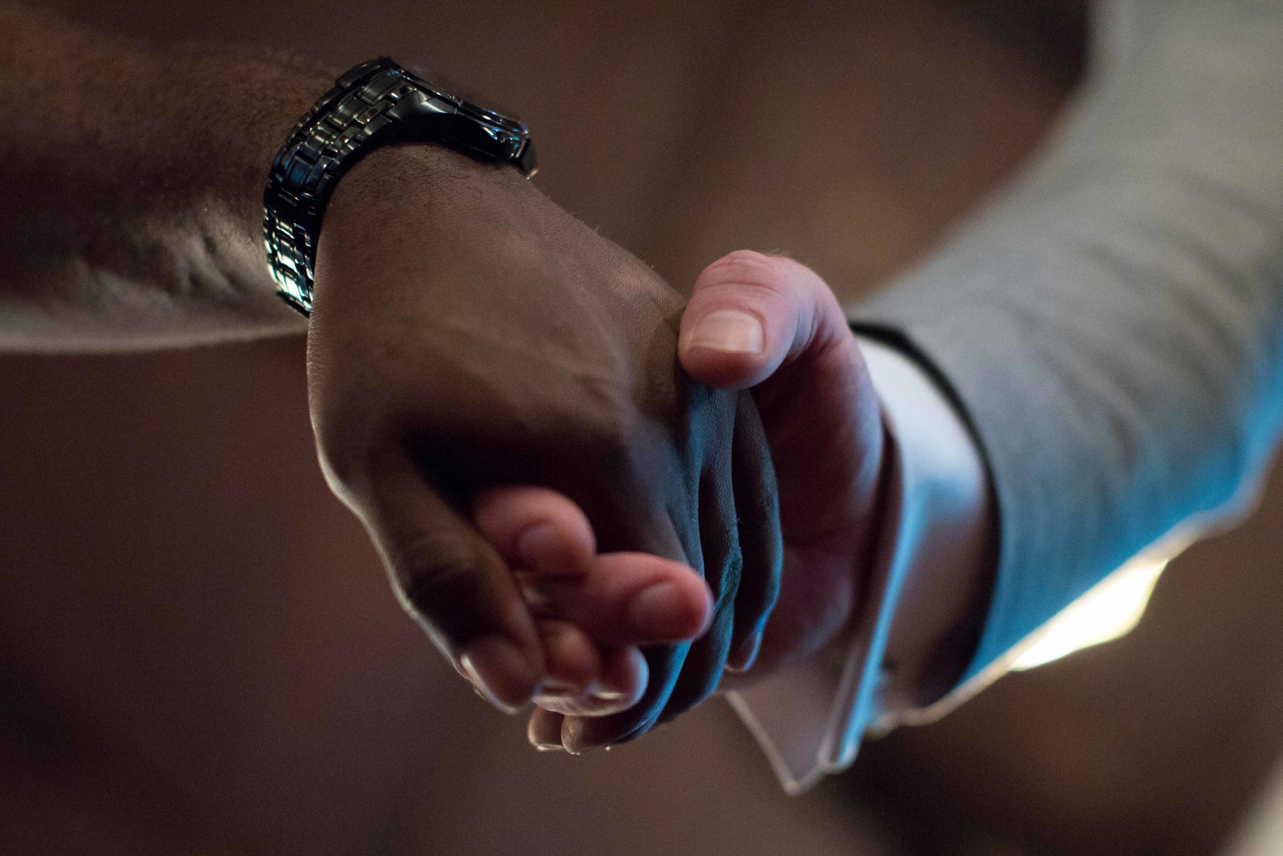 Paul Bronson, left, joins hands with District Attorney David Cooke during a Black Lives Matter prayer vigil at First Baptist Church, with a predominantly African-American congregation, in Macon, Ga., on Monday, July 11, 2016. Pastors of both First Baptist Churches in Macon are trying to bridge the stubborn divide of race against a painful and tumultuous backdrop. (AP Photo/Branden Camp)
