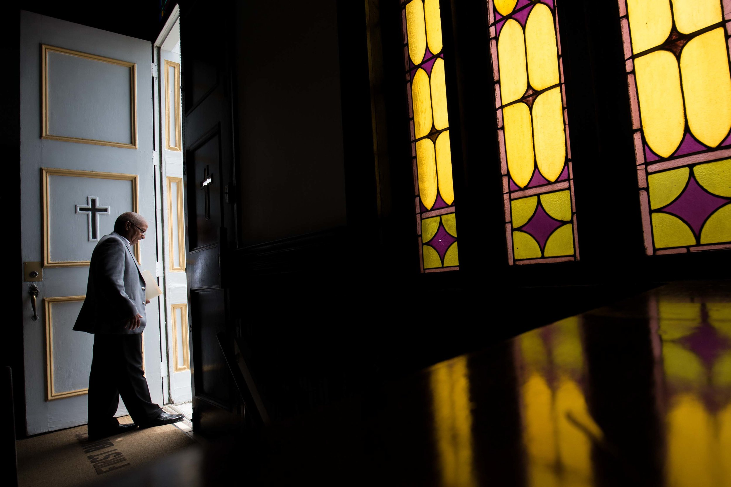 A parishioner at First Baptist Church, a predominantly African-American congregation, leaves after a worship service in Macon, Ga., on Sunday, July 10, 2016. There are two First Baptist Churches in Macon, one black and one white. (AP Photo/Branden Camp)