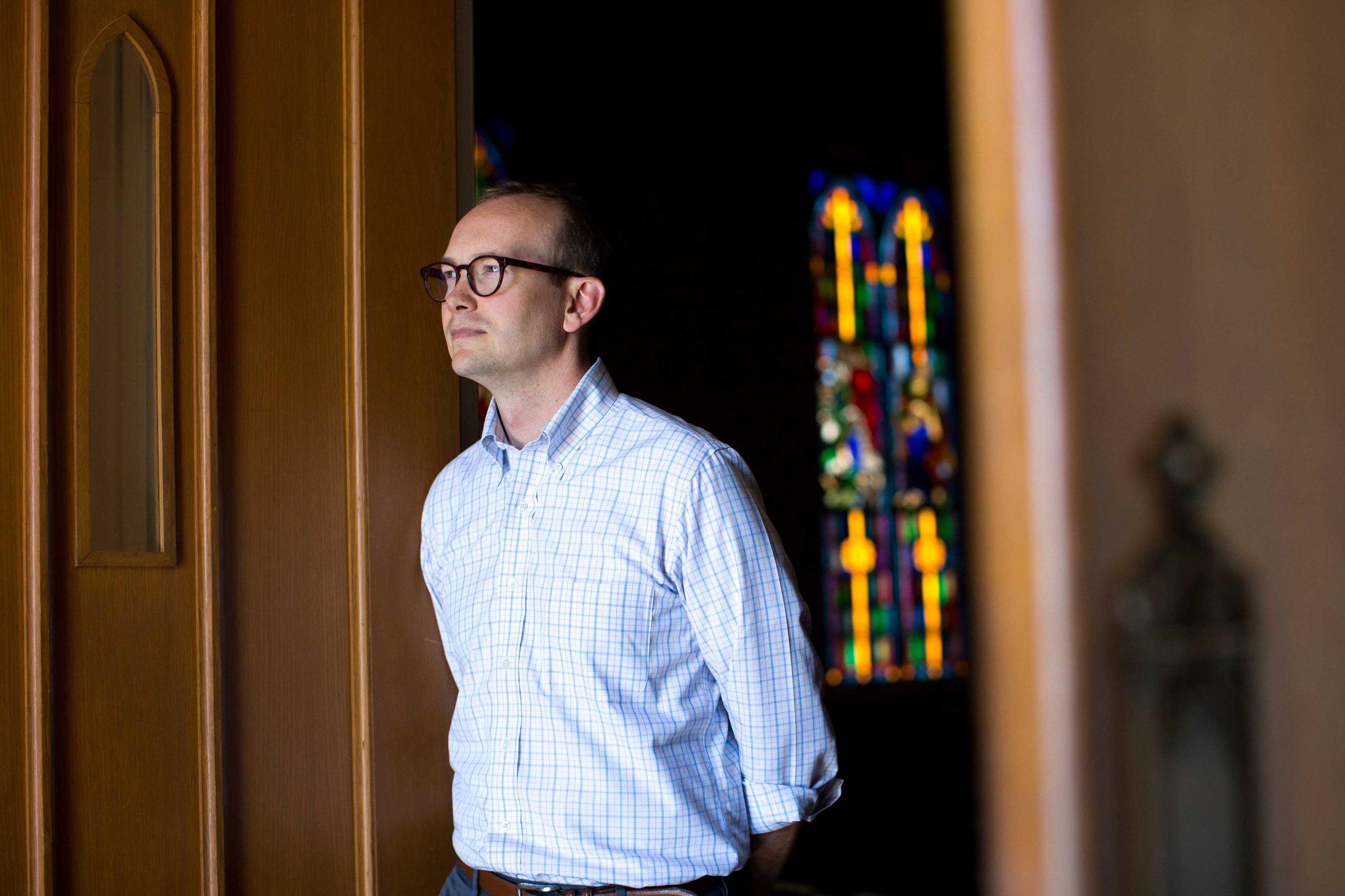 In this Monday, July 11, 2016 photo, the Rev. Scott Dickison poses for a portrait at the First Baptist Church of Christ, a predominantly white congregation, in Macon, Ga. The 33-year-old North Carolina native and Harvard Divinity School graduate became the pastor about four years ago. (AP Photo/Branden Camp)