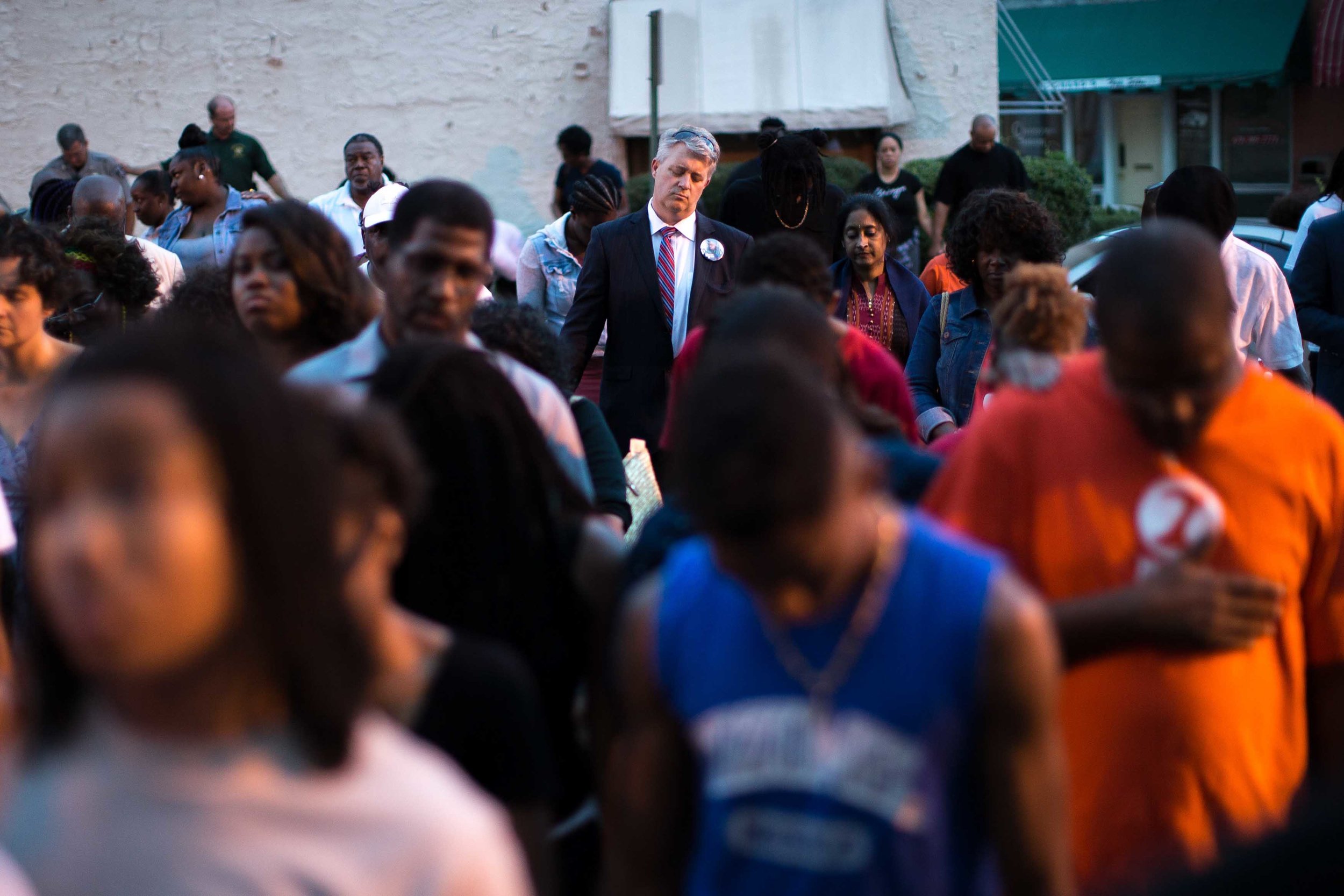 Members of the community join hands during a Black Lives Matter prayer vigil in front of the First Baptist Church, a predominantly African-American congregation, in Macon, Ga., on Monday, July 11, 2016. The pastors of both First Baptist Churches in Macon are trying to bridge the stubborn divide of race against a painful and tumultuous backdrop: the 2015 massacre at a historic black church in Charleston, South Carolina; the much-publicized deaths of blacks at the hands of law enforcement; the rise of the Black Lives Matter movement, and the sniper killing of white Dallas police officers. (AP Photo/Branden Camp)