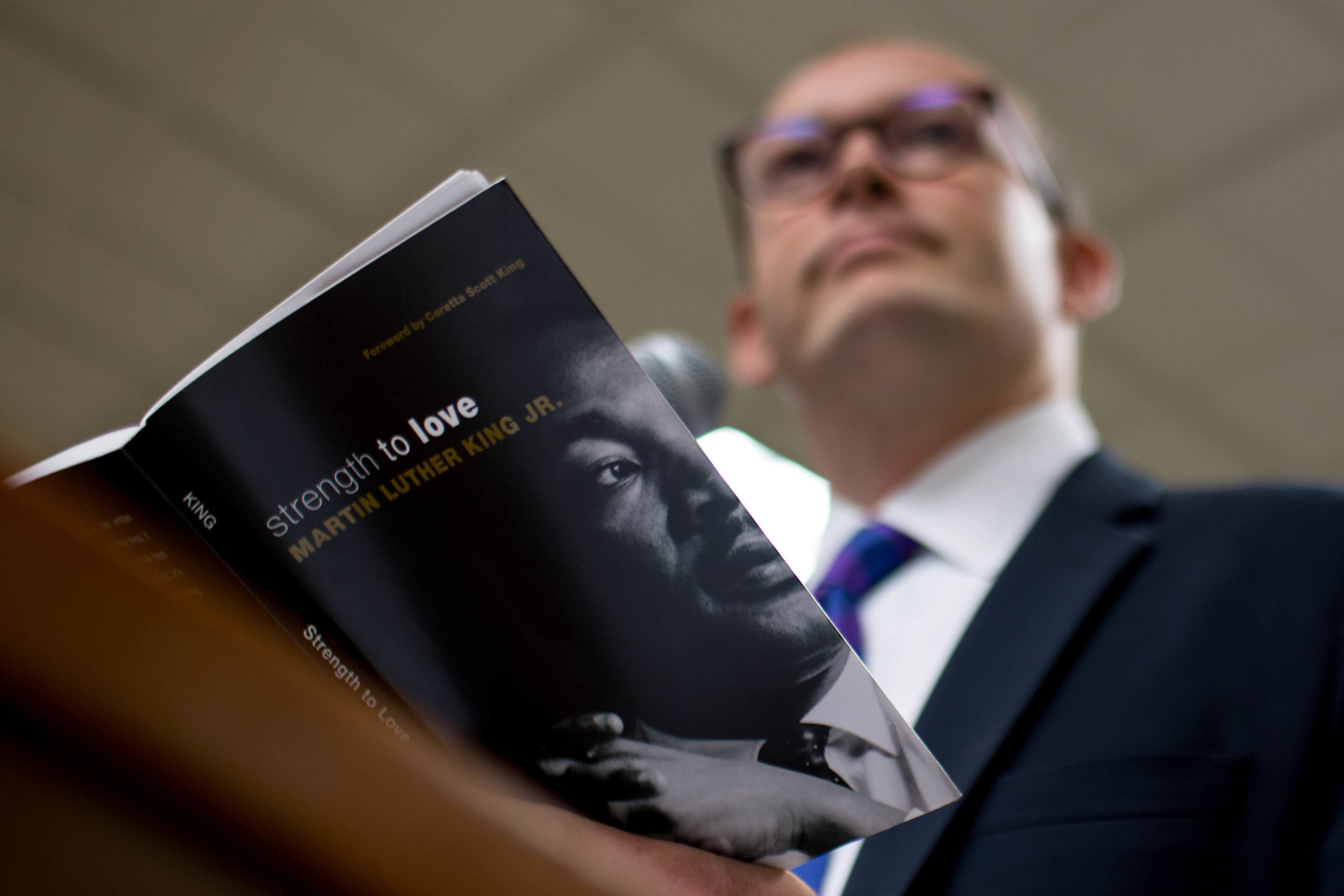 The Rev. Scott Dickison teaches from a book of sermons by Martin Luther King Jr. during a Sunday School class at the First Baptist Church of Christ, a predominantly white congregation, in Macon, Ga., on Sunday, July 10, 2016. This class was held days after the fatal police shootings of Alton Sterling in Louisiana and Philando Castile in Minnesota, and the fatal ambush on Dallas police. "It’s weeks like these when we need more than ever to be with God’s people," Dickison told the roomful of congregants. (AP Photo/Branden Camp