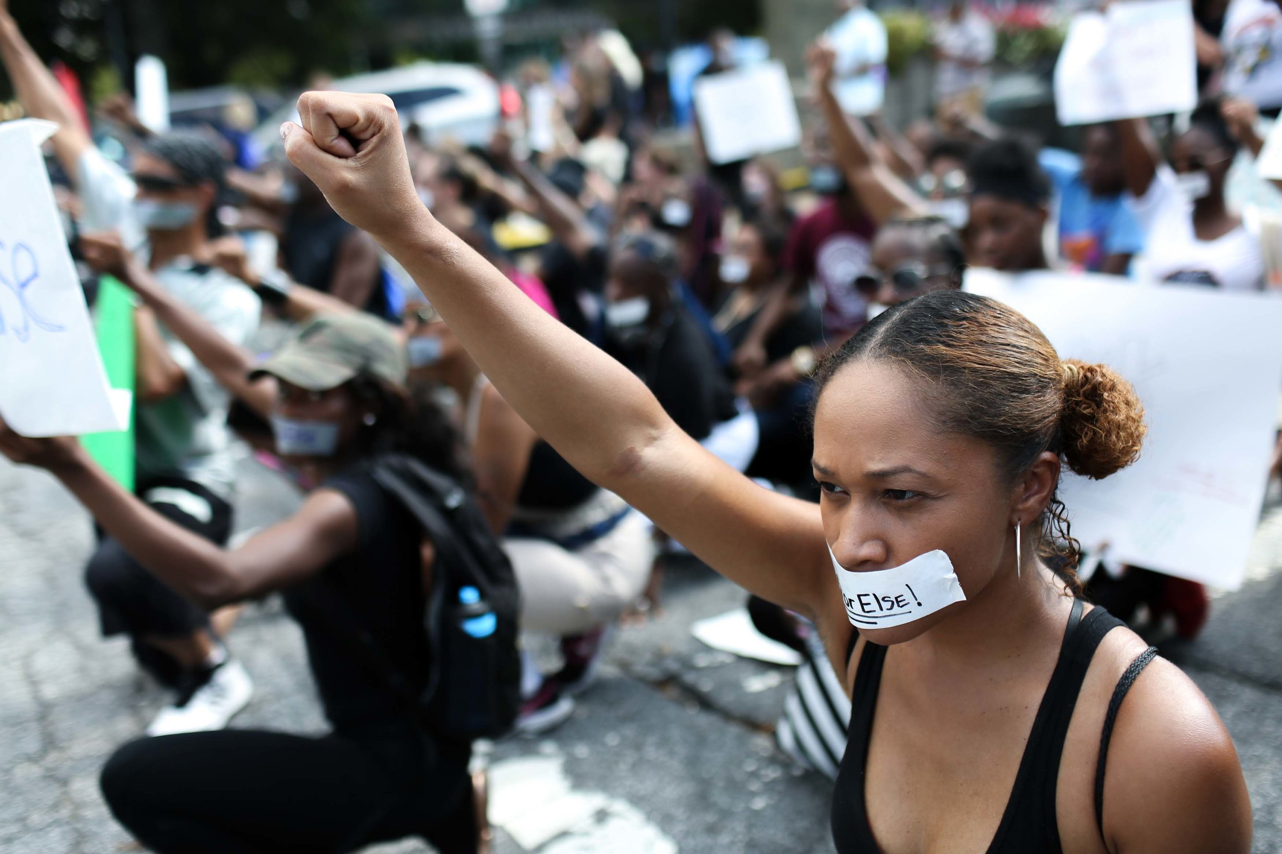 Demonstrators block an entrance to Lenox Square Mall during a Black Lives Matter protest in Atlanta, Saturday, Sept. 24, 2016, in response to the police shooting deaths of Terence Crutcher in Tulsa, Okla. and Keith Lamont Scott in Charlotte, N.C. The Black Lives Matter chapter of Atlanta is boycotting major retailers following the recent police shooting deaths involving black men. (AP Photo/Branden Camp)