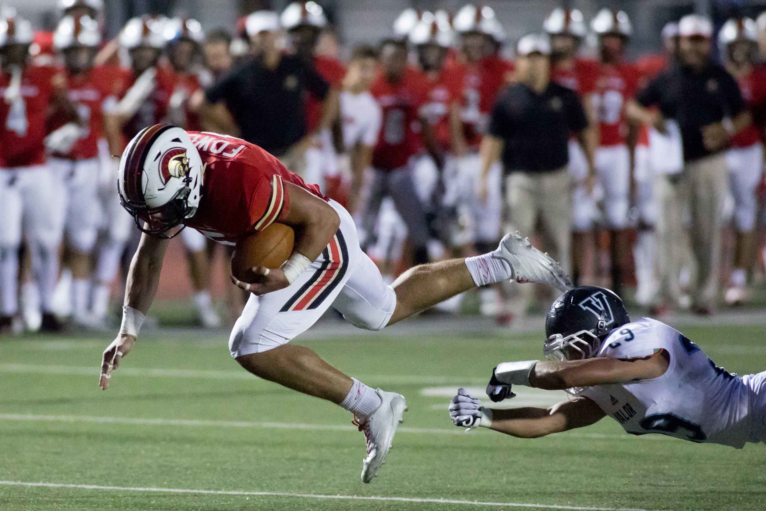 Greater Atlanta Christian's Robby Fowler (5) converts a fourth down run for a first down as he eludes the tackle from Valor Christian's Chase Lopez (29) during a high school football game against Valor Christian of Colorado, Friday, Sept. 8, 2017, in Norcross, Ga. Branden Camp for The AJC