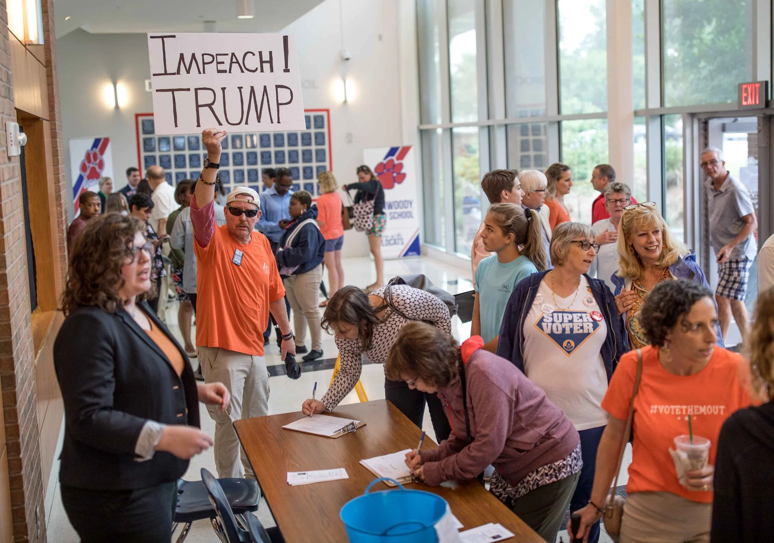 Robert Wofford holds a sign before a town hall with Rep. Lucy McBath, D-Ga., at Dunwoody High School on Saturday, June 8, 2019 in Dunwoody, Ga. Branden Camp for AJC