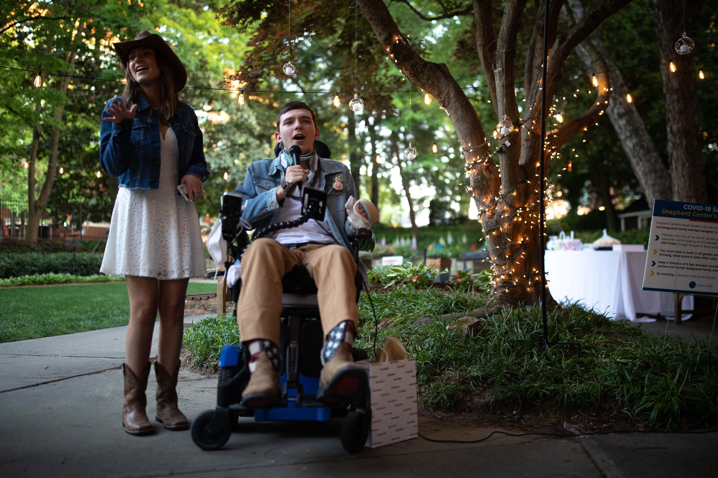  Lilly Ray, left, sings with her prom date Shepherd Center patient Aiden Gilligan during Enchanted Garden, a prom night held for patients at the Shepherd Center on Friday, April 22, 2022, in Atlanta. Branden Camp/For the Atlanta Journal-Constitution 