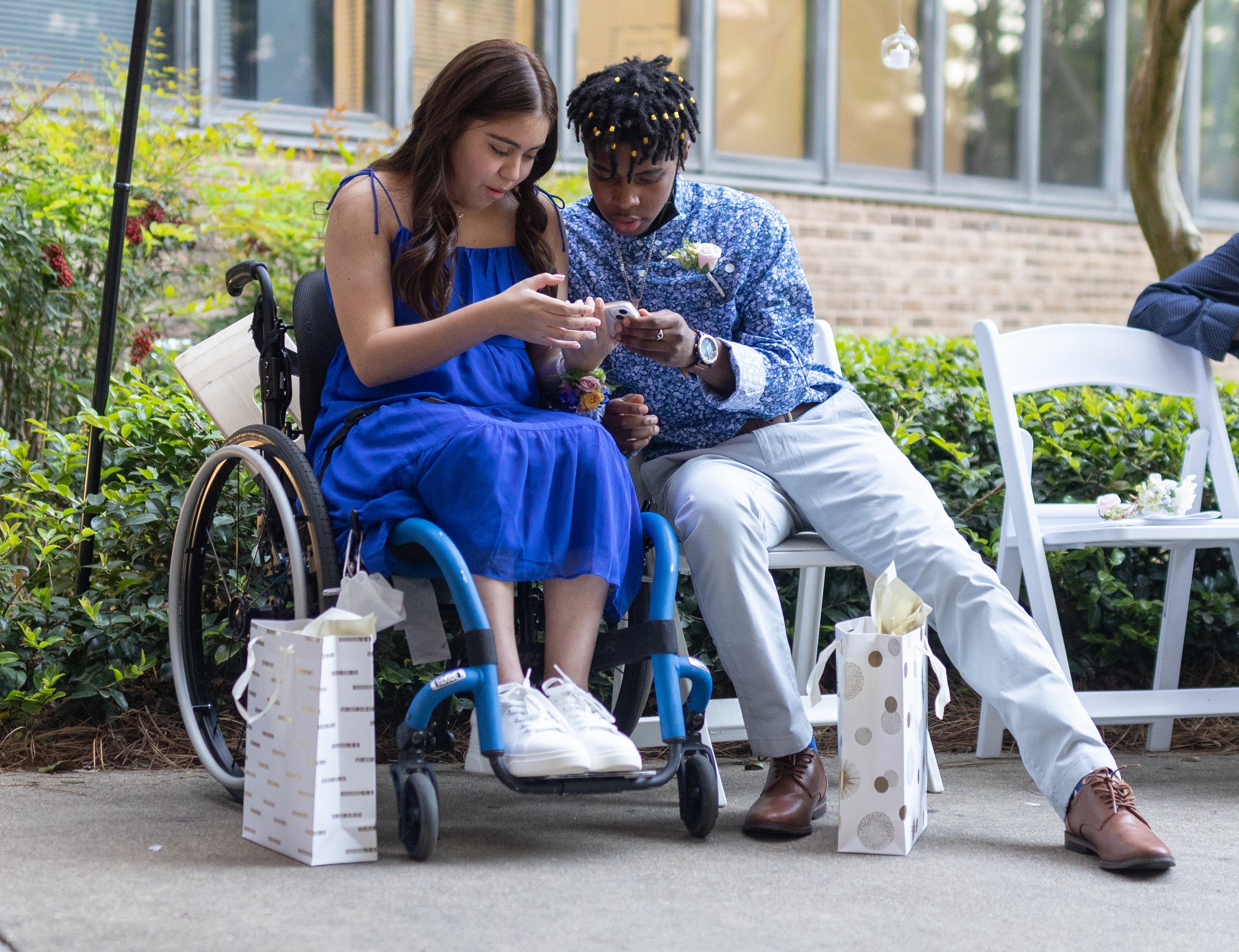  Shepherd Center patients Maria Manley, left, and Dontae Wilson watch a video on a phone during Enchanted Garden, a prom night held for patients at the Shepherd Center on Friday, April 22, 2022, in Atlanta. Branden Camp/For the Atlanta Journal-Consti