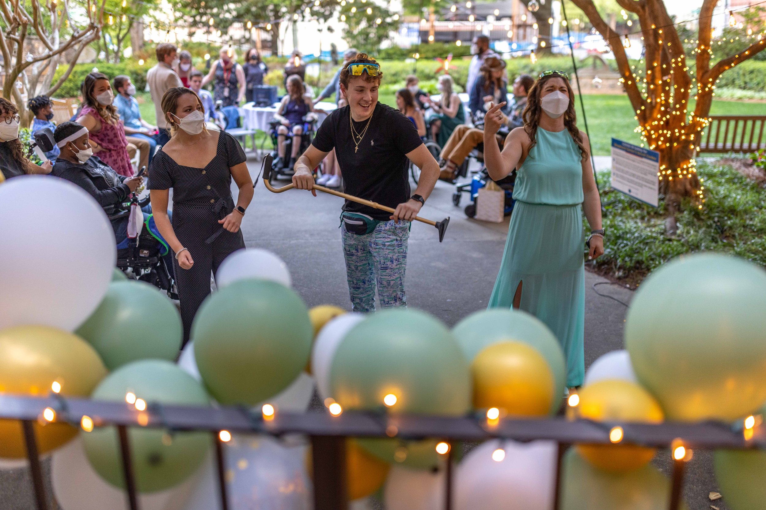  Shepherd Center patient Dom LaRusso, center, dances with Recreational Therapist Avery Blankenship, left, and   Exercise Physiologist Kelly White, right, during Enchanted Garden, a prom night held for patients at the Shepherd Center on Friday, April 