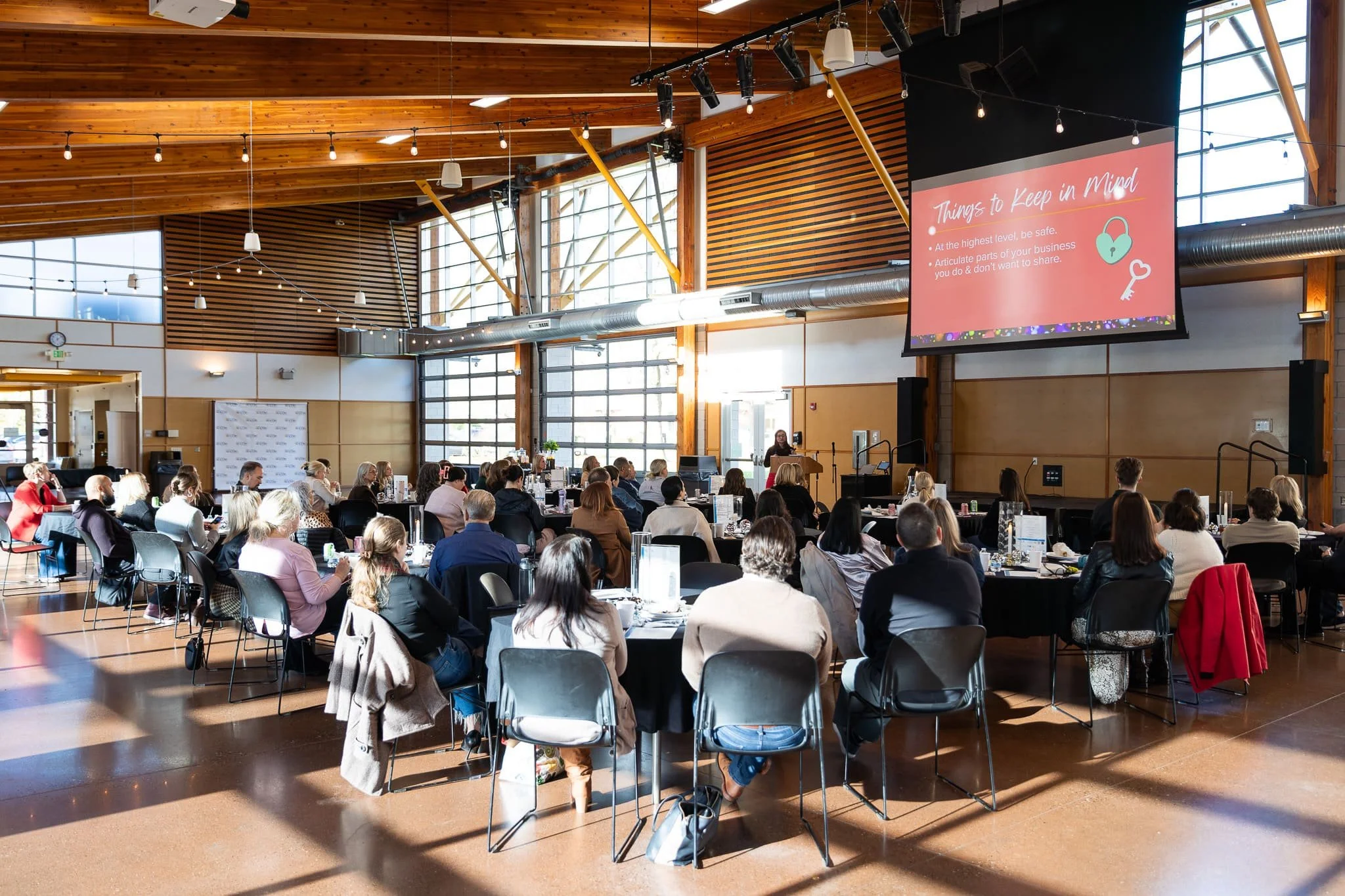 Wide view of the audience and presentation screen inside Pioneer Pavilion