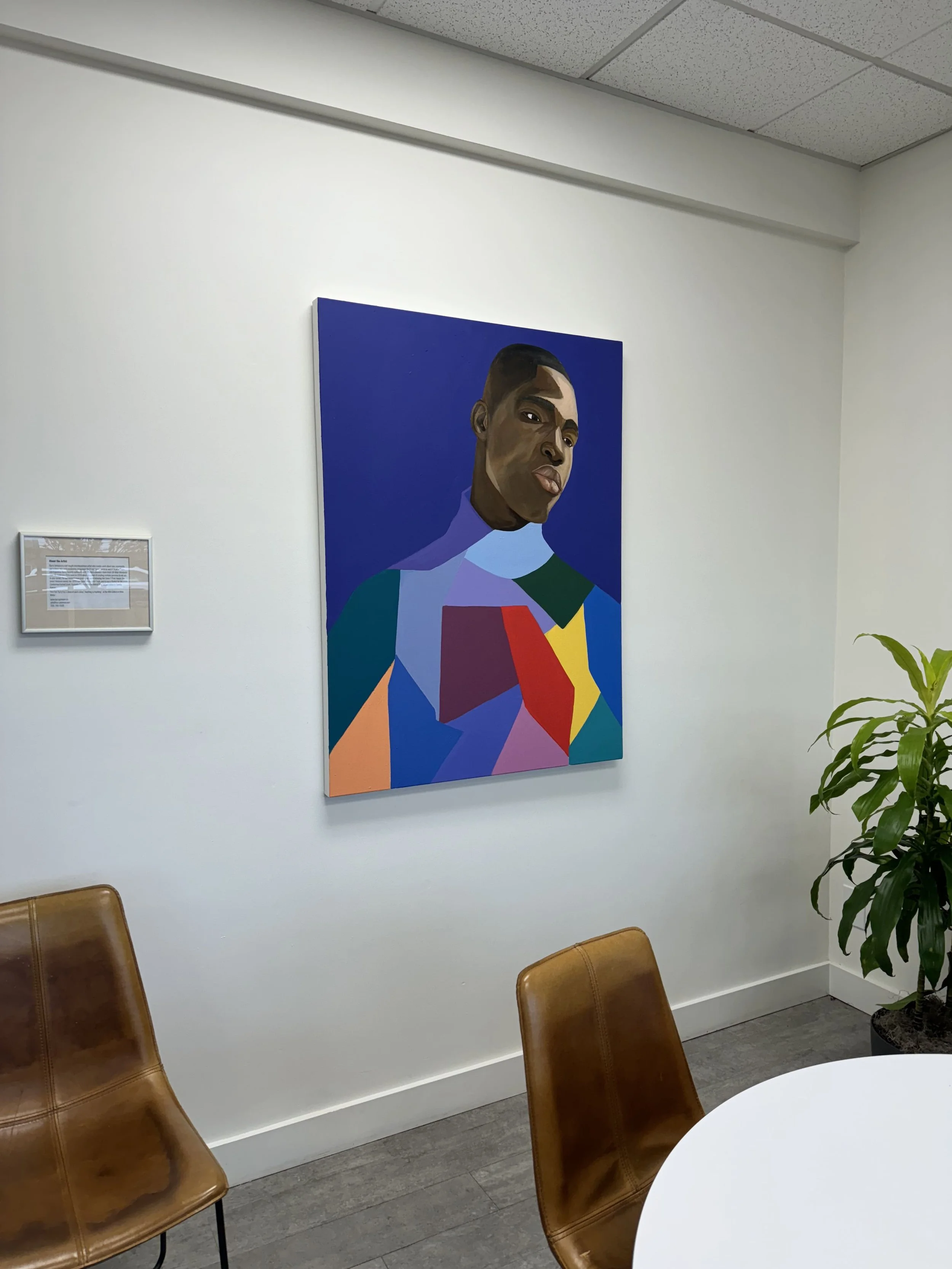 Vibrant portrait by Barry Johnson featuring glasses and colorful geometric shapes, displayed at Windermere Abode.