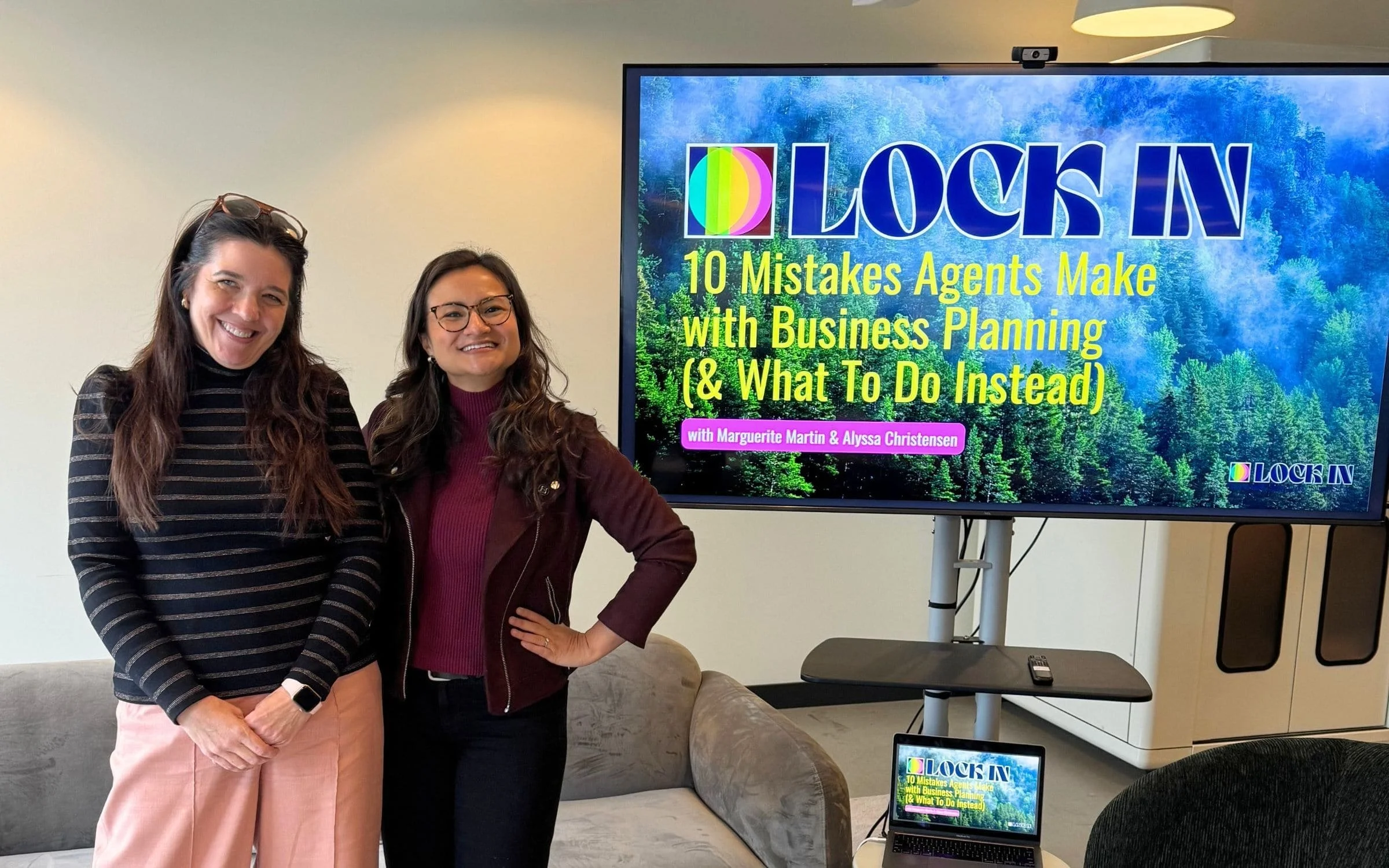 Alyssa Christensen and Marguerite Martin standing beside their Lock In business planning presentation at Ensemble in Seattle.
