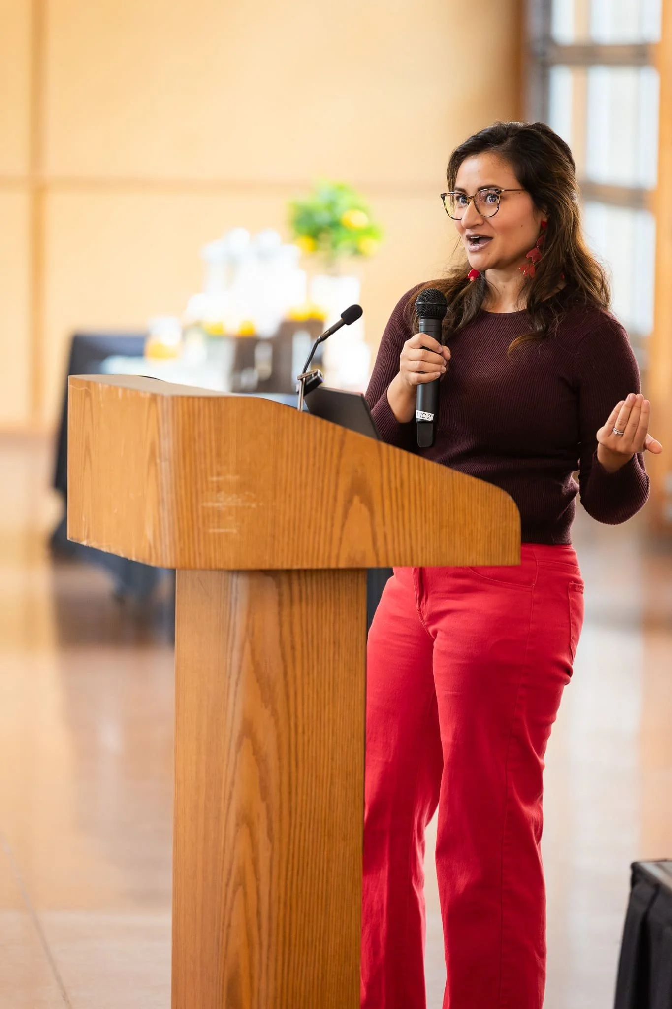 Alyssa W. Christensen presenting at a podium during a real estate marketing event