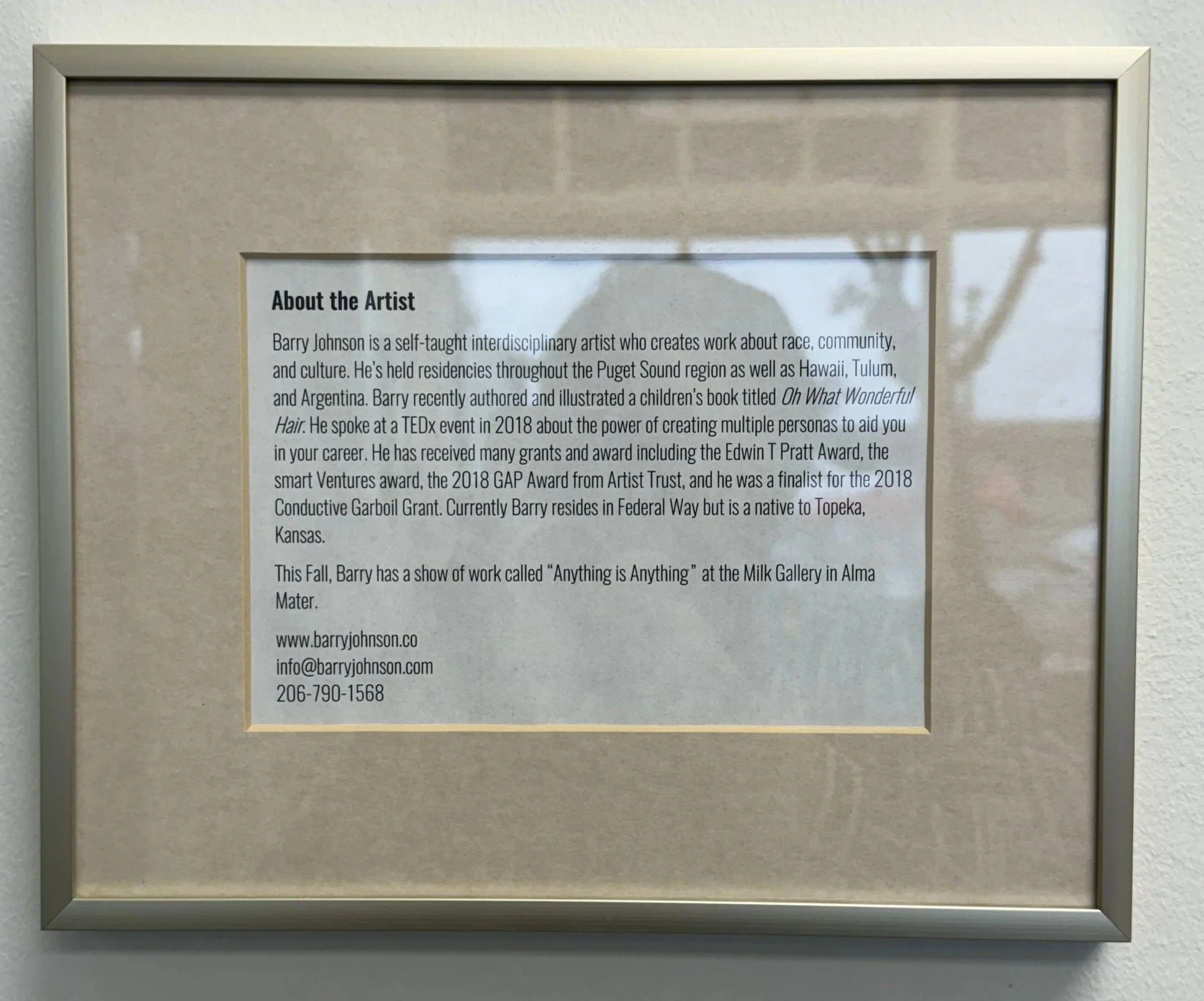 Framed biography of interdisciplinary artist Barry Johnson displayed inside Windermere Abode's office.