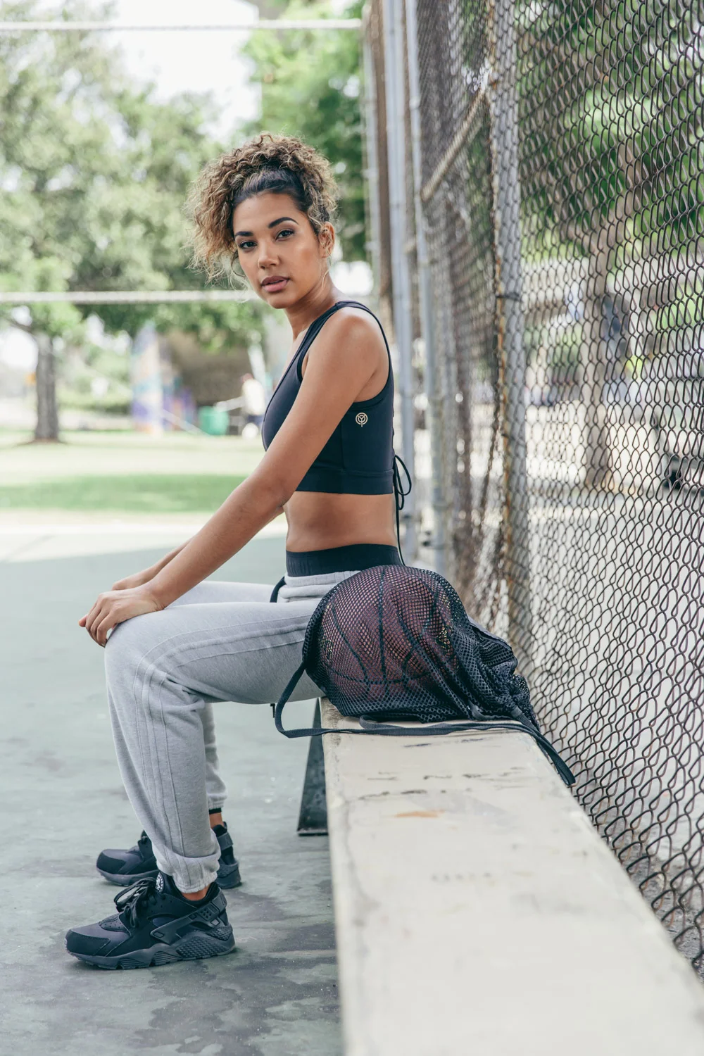 Year of Ours Sports portraits by Jenny Siegwart: Woman in sports bra on the basketball court
