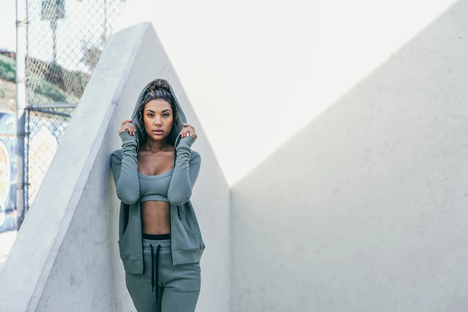 Year of Ours Sports portraits by Jenny Siegwart: Woman in a sports bra with a hoodie on